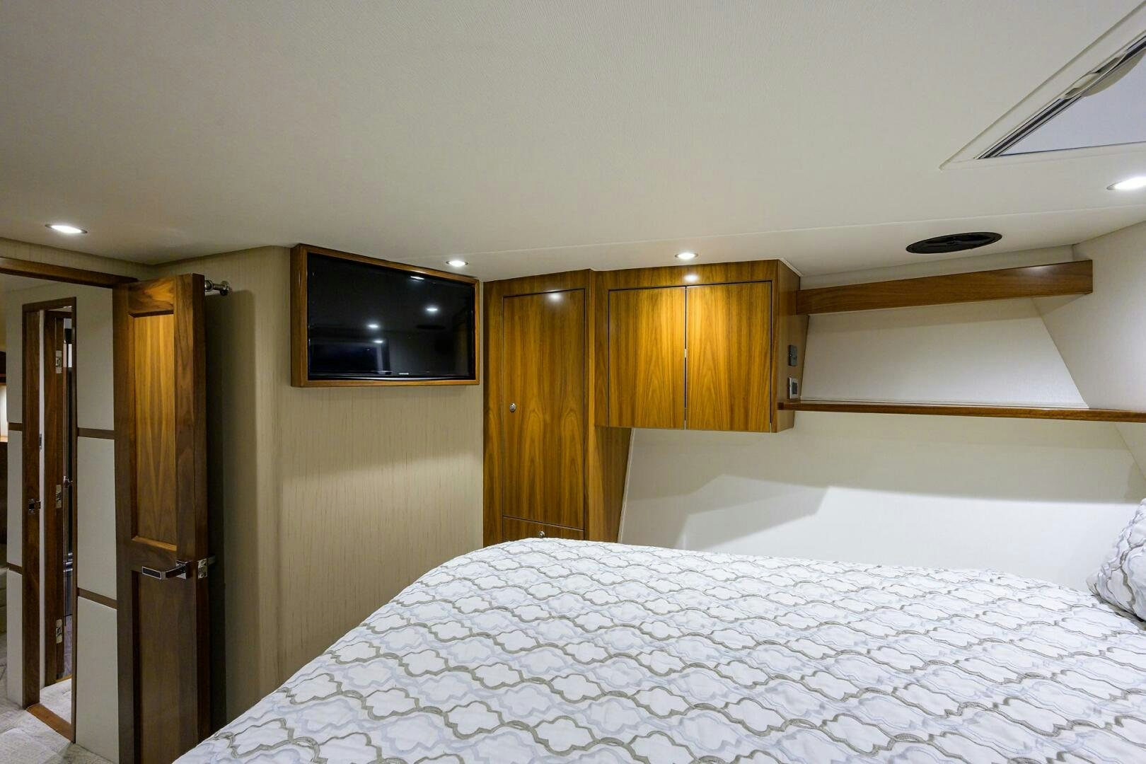 a bedroom with a tv on the wall aboard SNOWBIRD Yacht for Sale