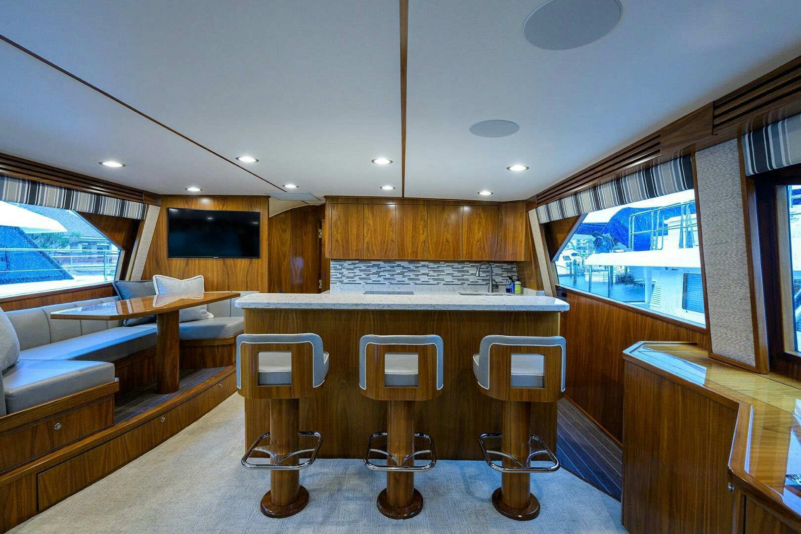 a room with a table and stools aboard SNOWBIRD Yacht for Sale