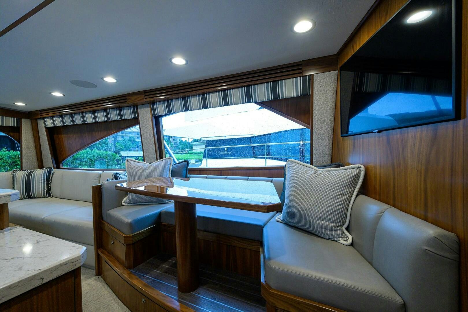 a living room with a large window aboard SNOWBIRD Yacht for Sale