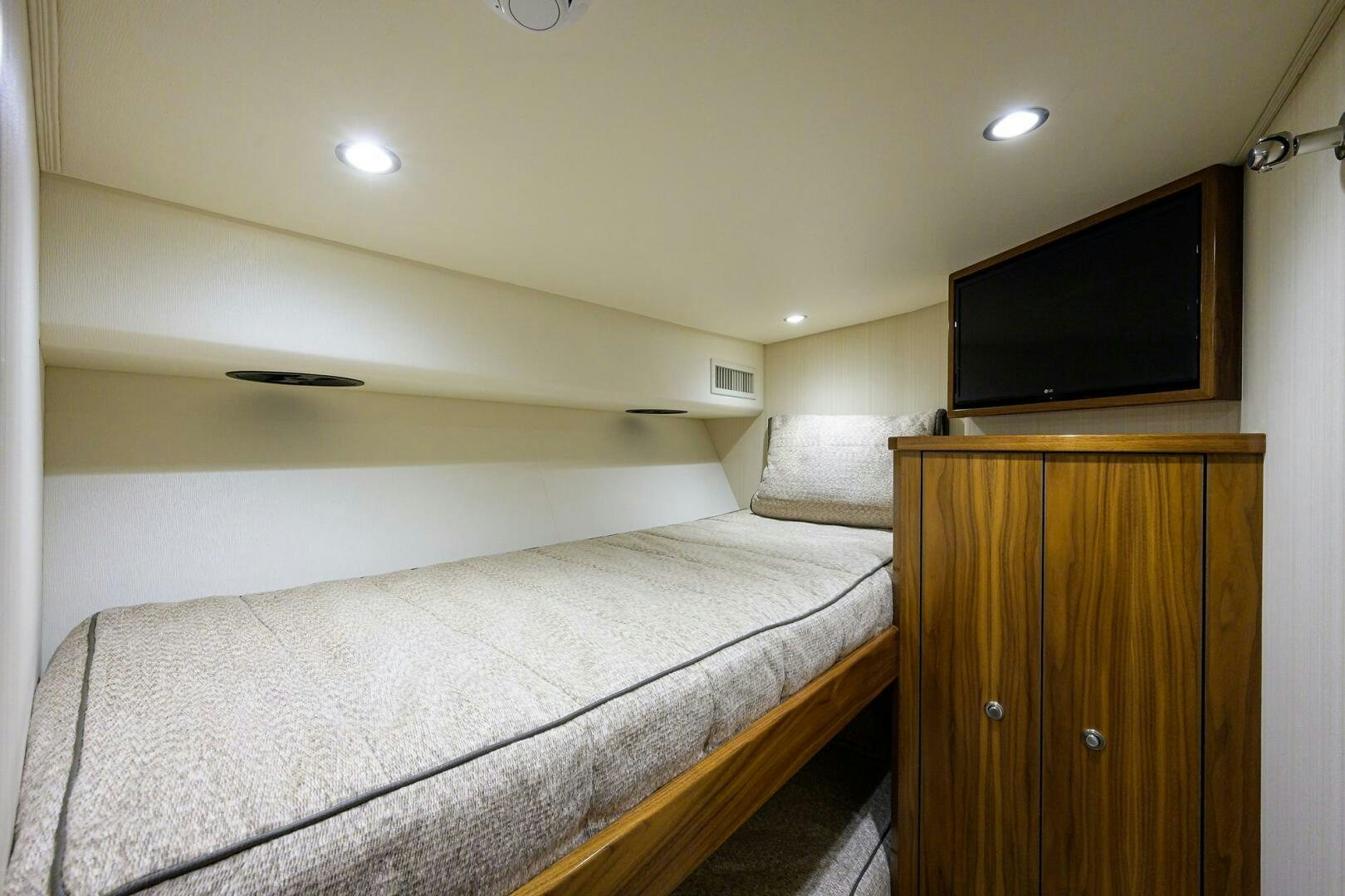 a bedroom with a bed and tv aboard SNOWBIRD Yacht for Sale