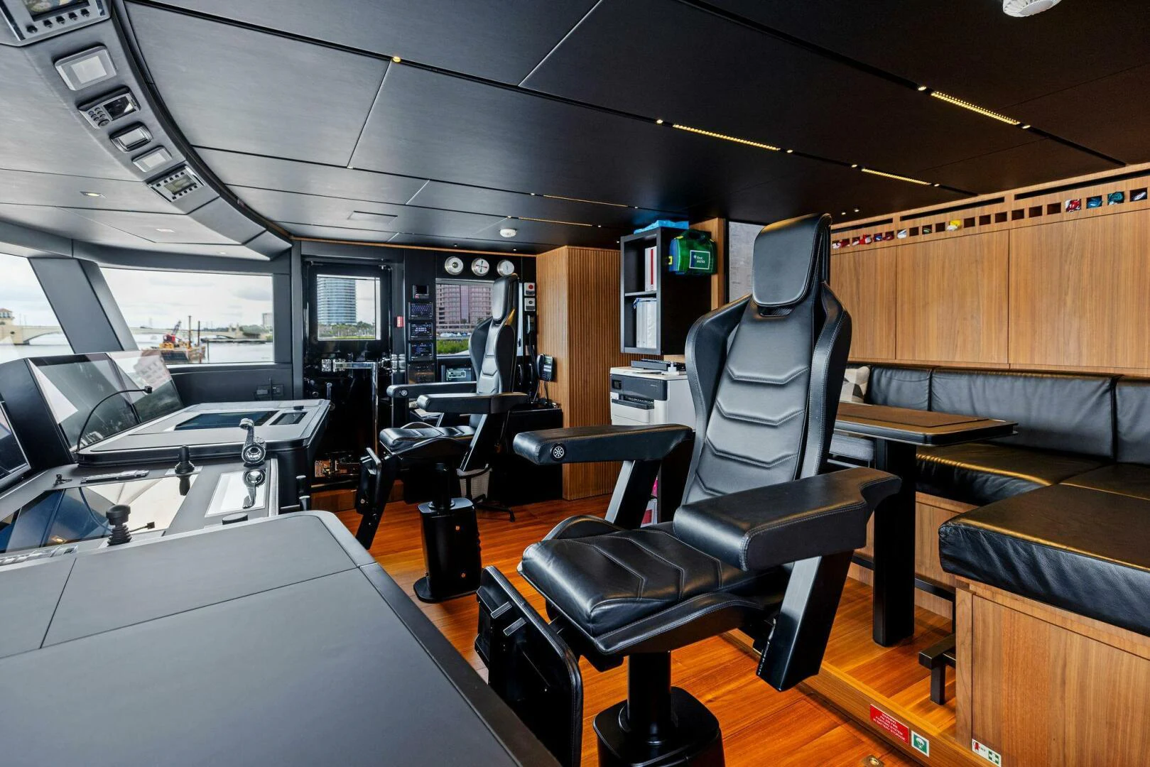 inside of a vehicle with desks and chairs aboard KAMAKASA Yacht for Sale