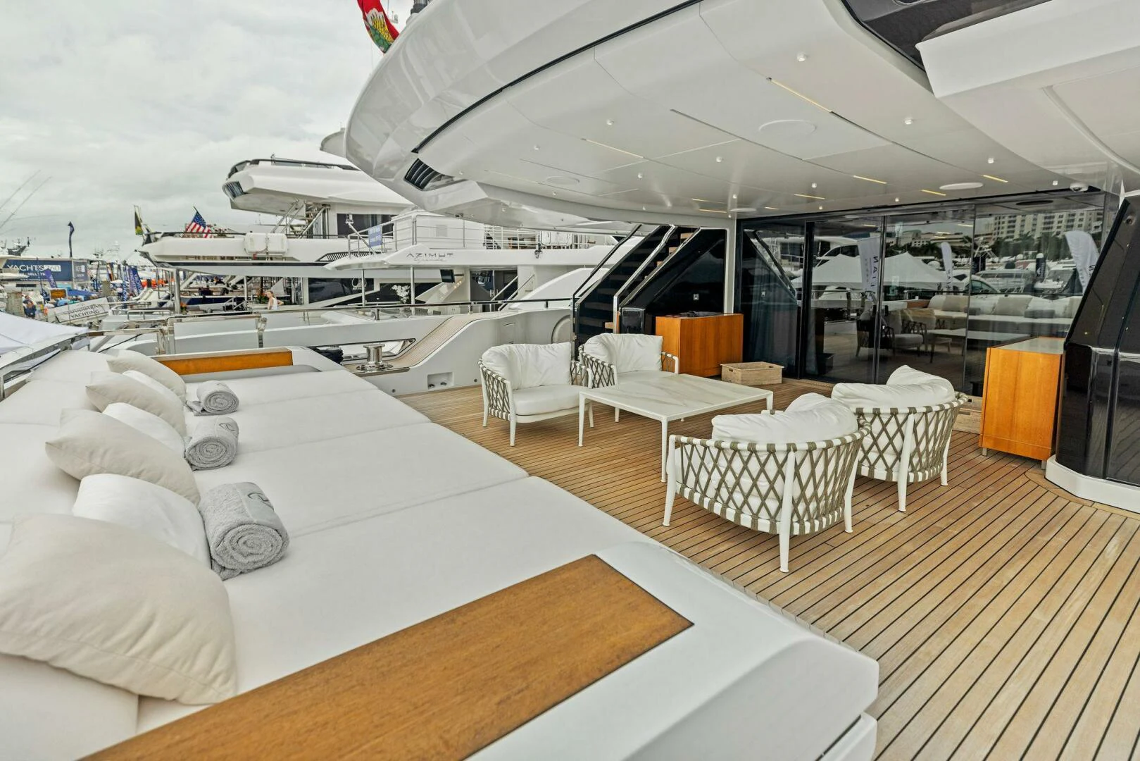 a room with a large bed and a table with chairs aboard KAMAKASA Yacht for Sale
