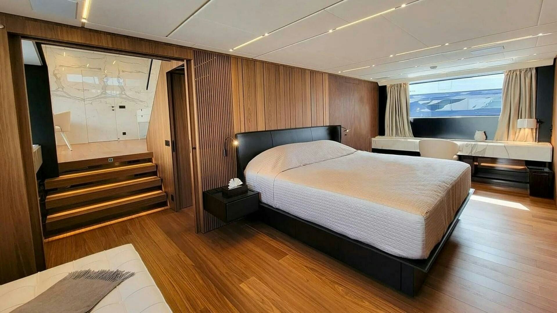 a large bedroom with a large bed aboard KAMAKASA Yacht for Sale