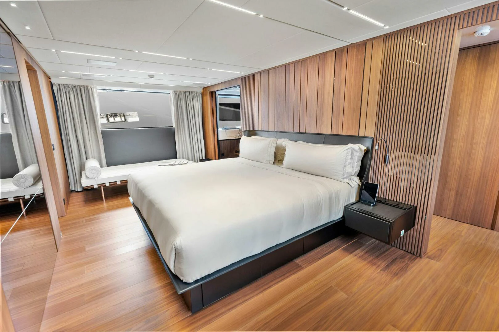 a room with a bed and a wood wall aboard KAMAKASA Yacht for Sale