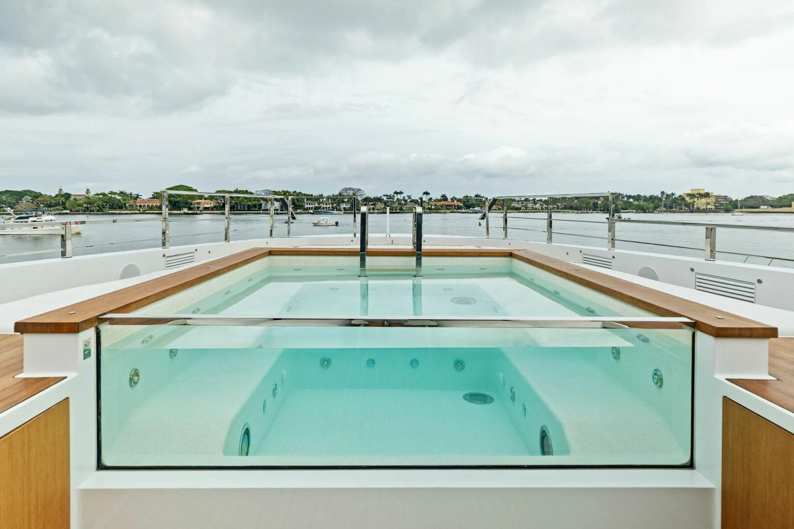 a pool with a deck and a view of the water aboard KAMAKASA Yacht for Sale