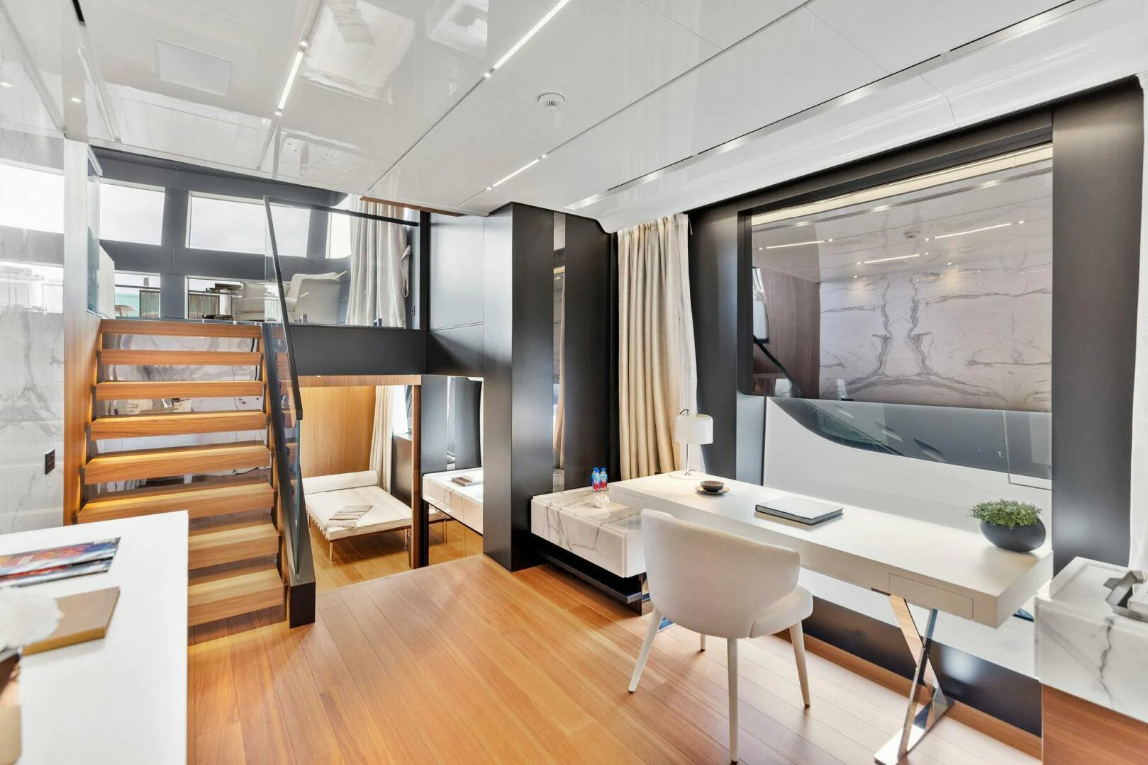 a room with a table chairs and a large mirror aboard KAMAKASA Yacht for Sale
