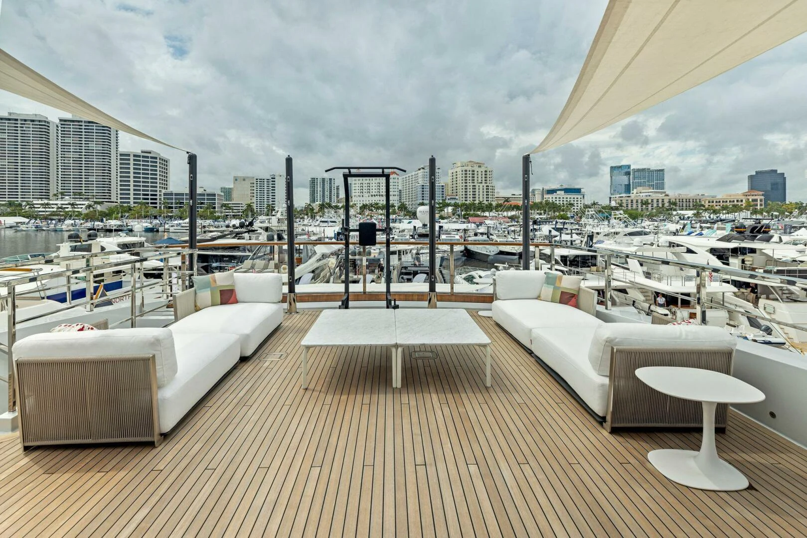 a room with a couch and a table on a deck aboard KAMAKASA Yacht for Sale