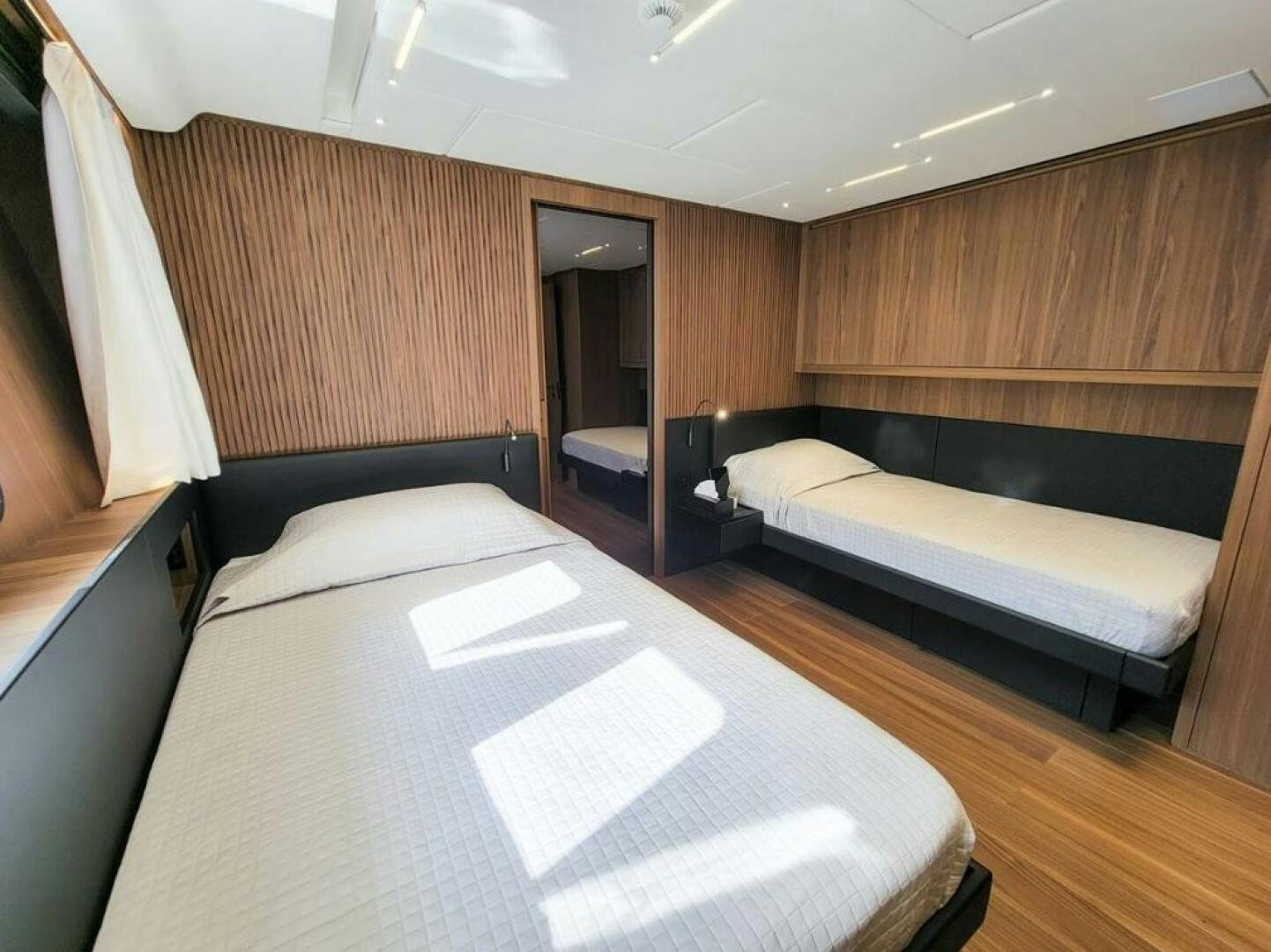 a room with a bed and a desk aboard KAMAKASA Yacht for Sale