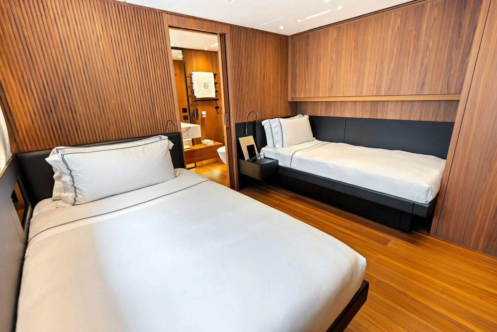 a room with a bed and a desk aboard KAMAKASA Yacht for Sale