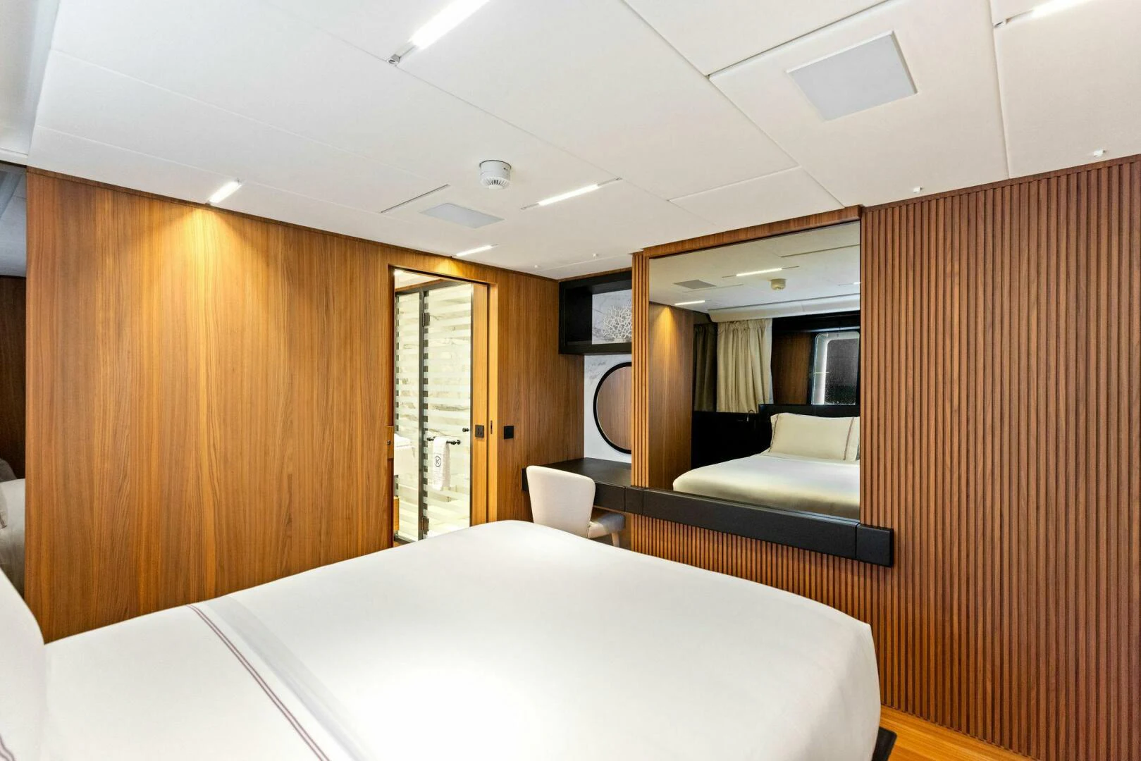 a room with a bed and a desk aboard KAMAKASA Yacht for Sale