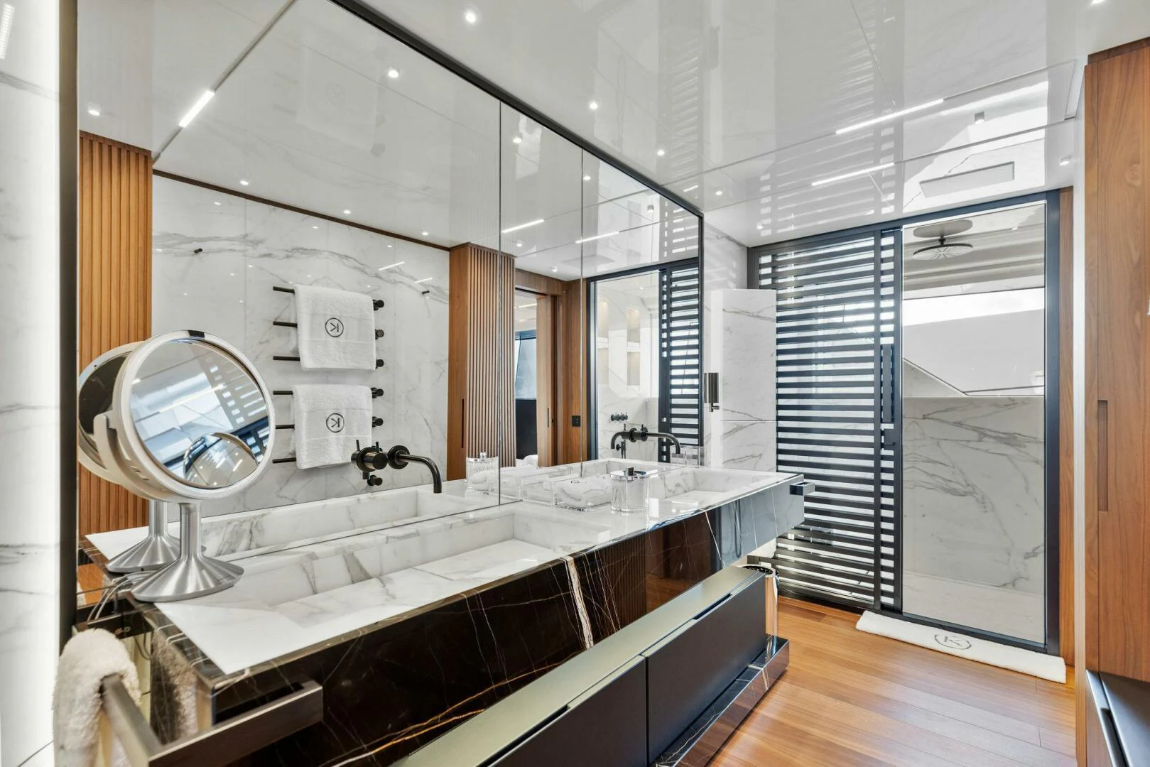 a bathroom with a large mirror aboard KAMAKASA Yacht for Sale