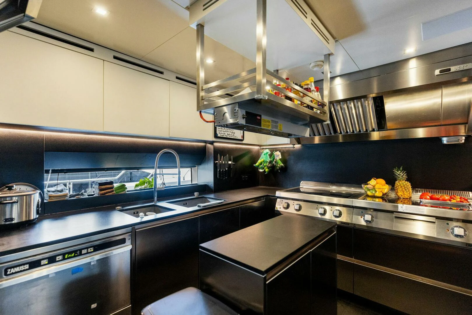 a kitchen with stainless steel appliances aboard KAMAKASA Yacht for Sale