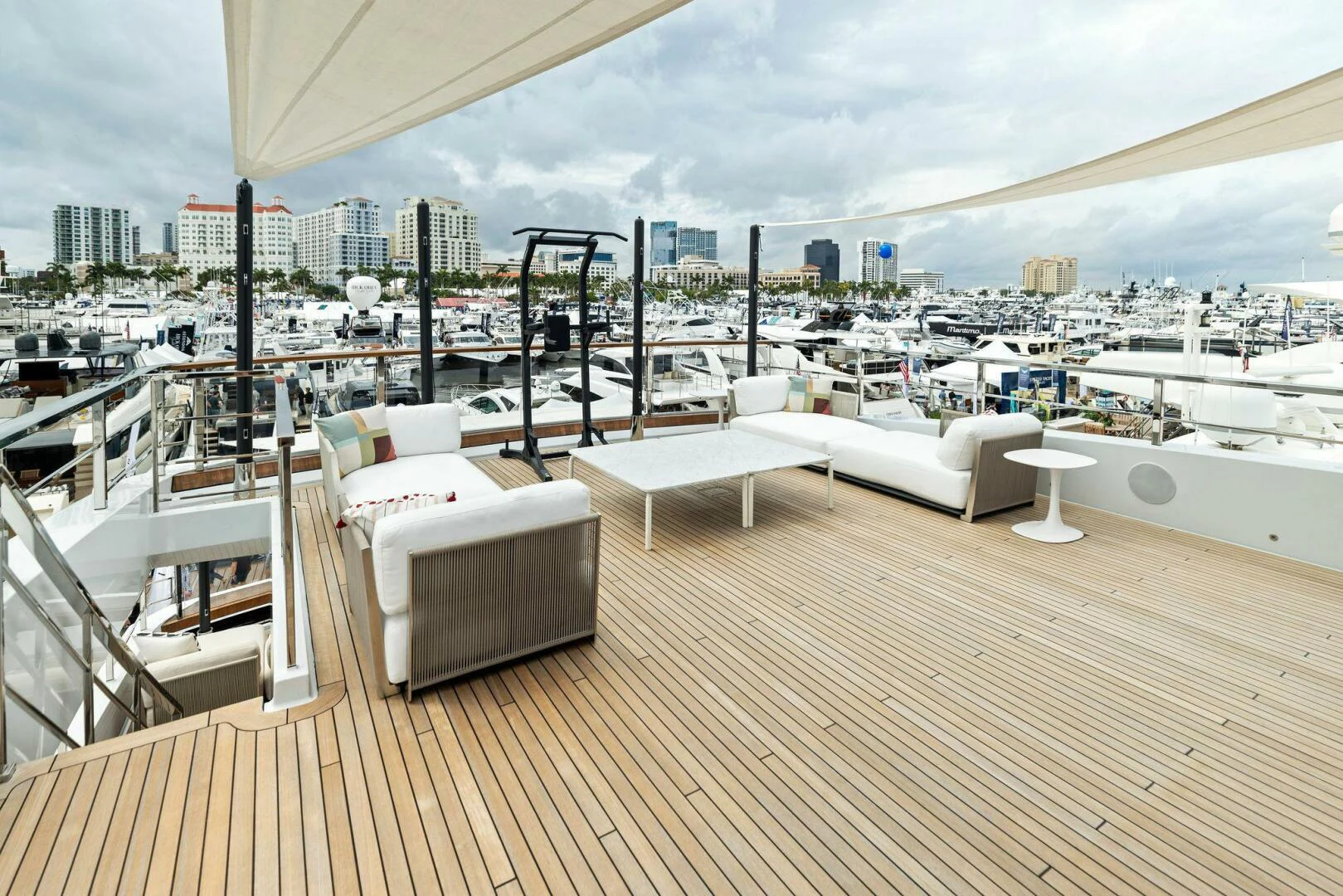 a deck with a view of a city and a large body of water aboard KAMAKASA Yacht for Sale