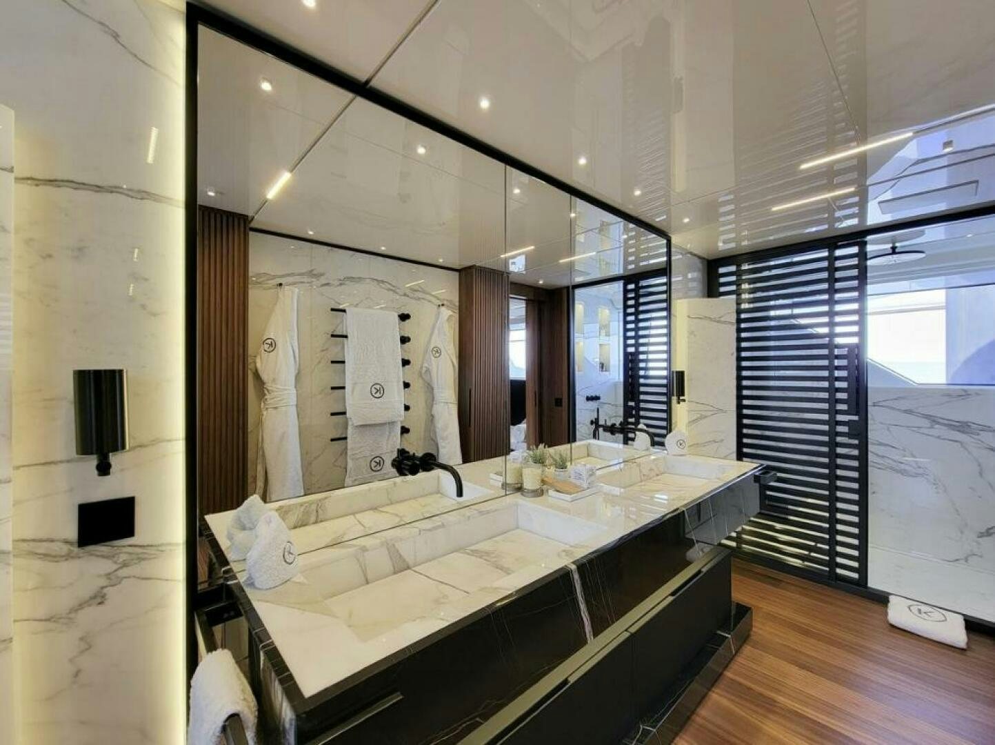 a large bathroom with a large mirror aboard KAMAKASA Yacht for Sale