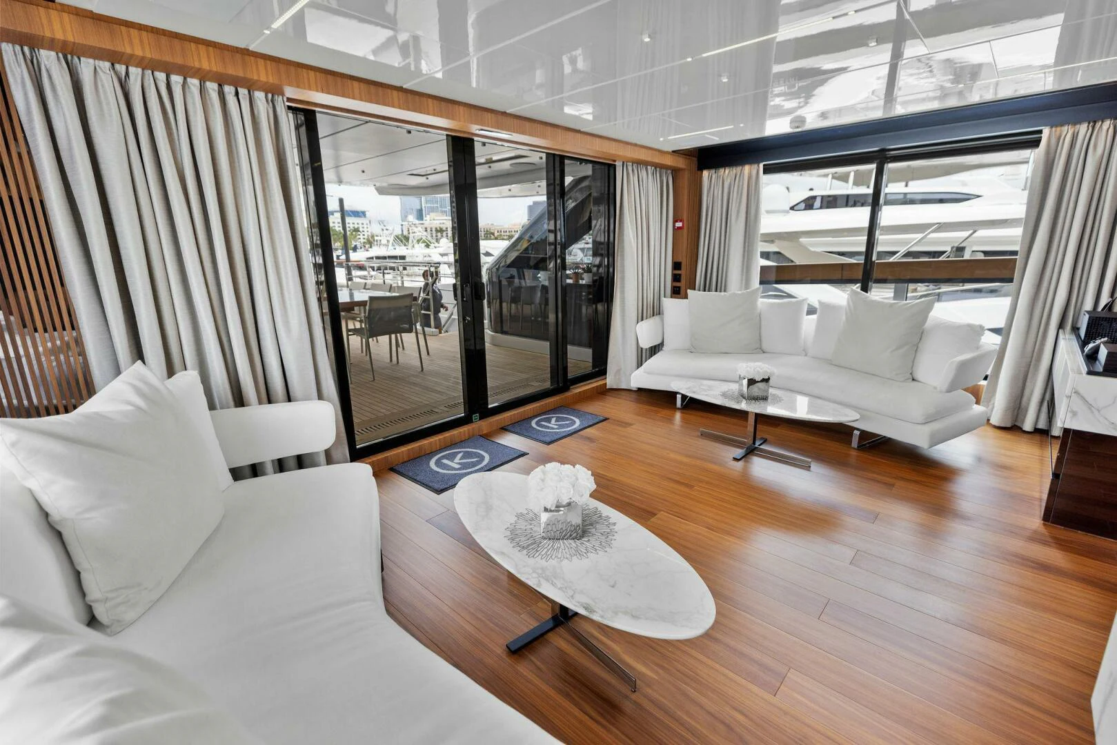 a living room with a large window aboard KAMAKASA Yacht for Sale
