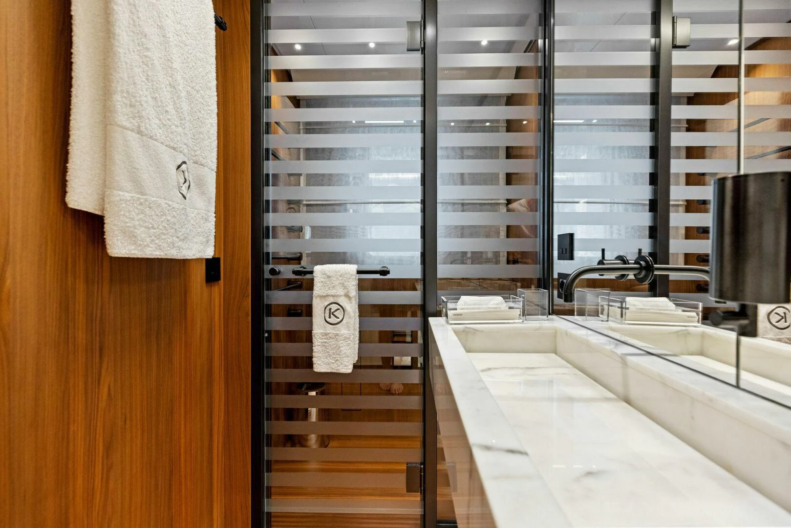 a bathroom with a tub and shower aboard KAMAKASA Yacht for Sale
