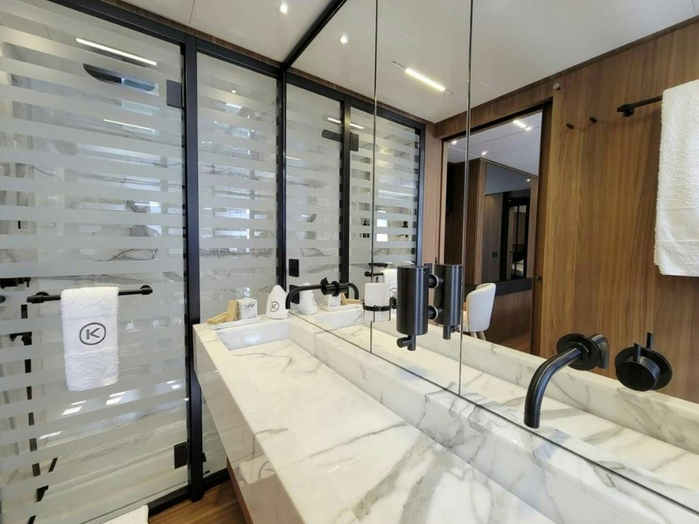 a bathroom with a large mirror aboard KAMAKASA Yacht for Sale
