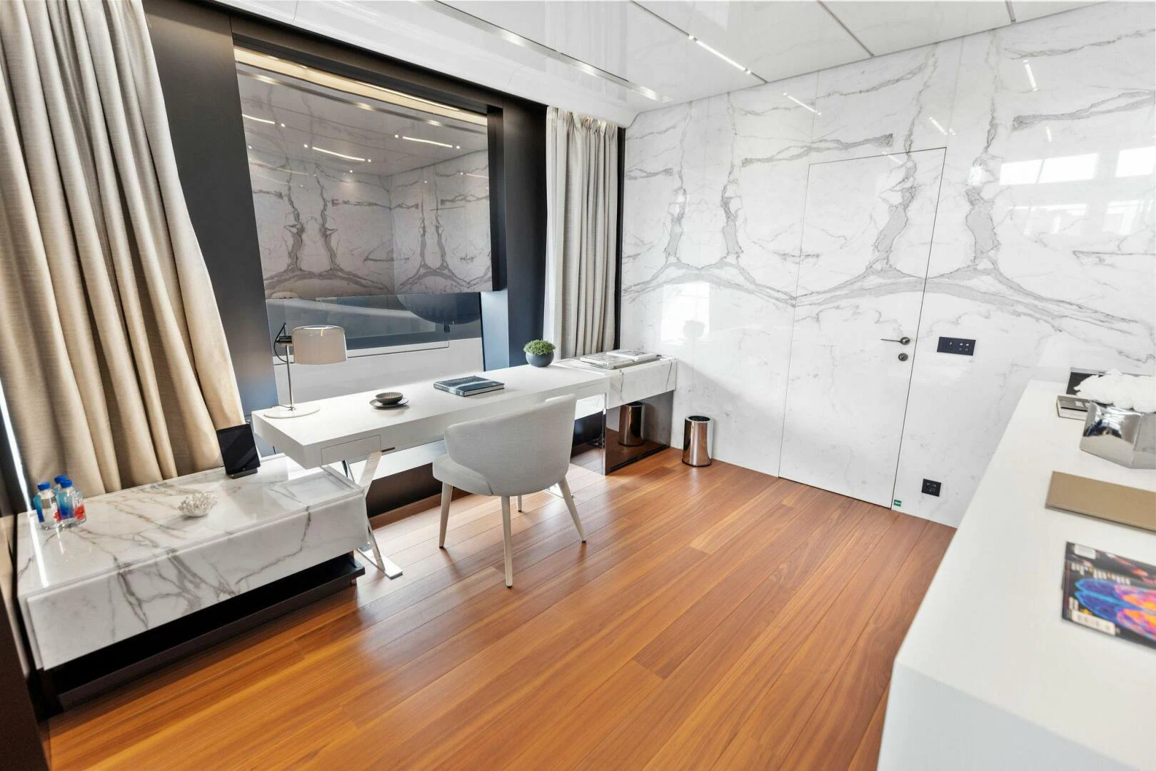 a room with a bed and desk aboard KAMAKASA Yacht for Sale