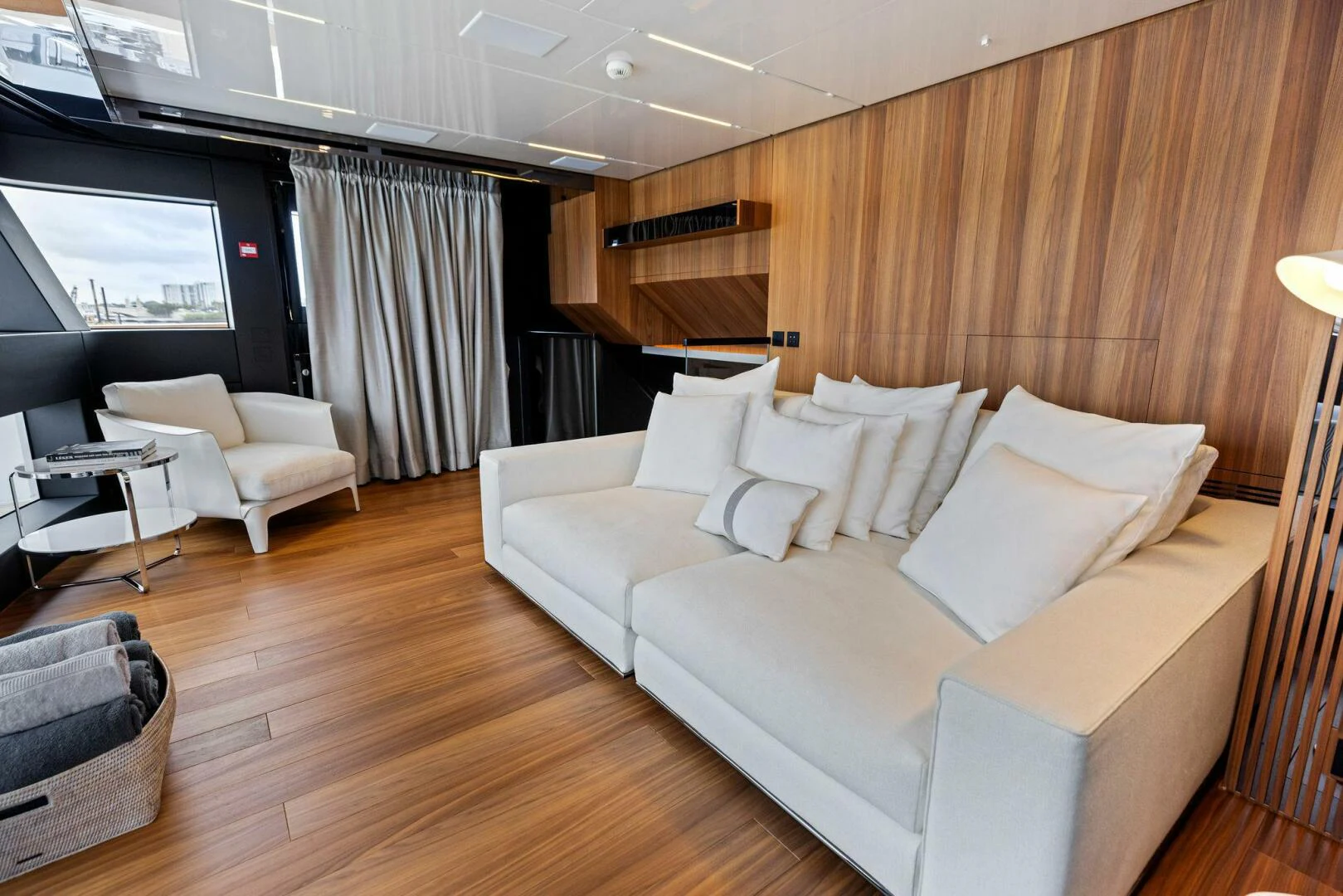 a living room with a large wood wall aboard KAMAKASA Yacht for Sale