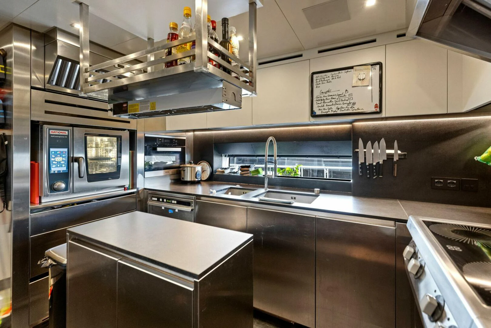 a kitchen with stainless steel appliances aboard KAMAKASA Yacht for Sale