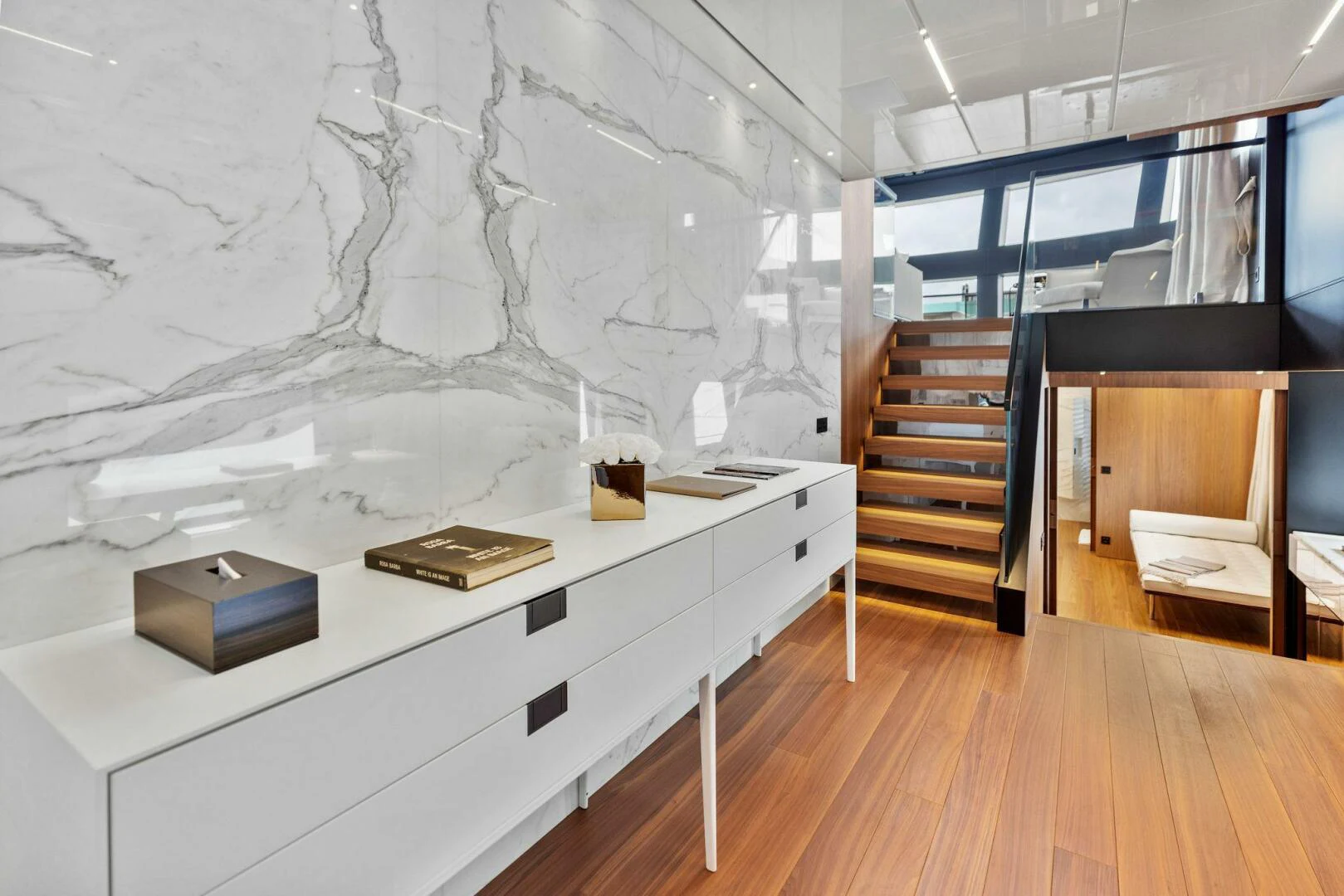 a room with a desk and a book on the table aboard KAMAKASA Yacht for Sale