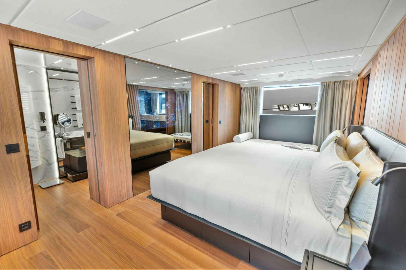 a room with a bed and a mirror aboard KAMAKASA Yacht for Sale