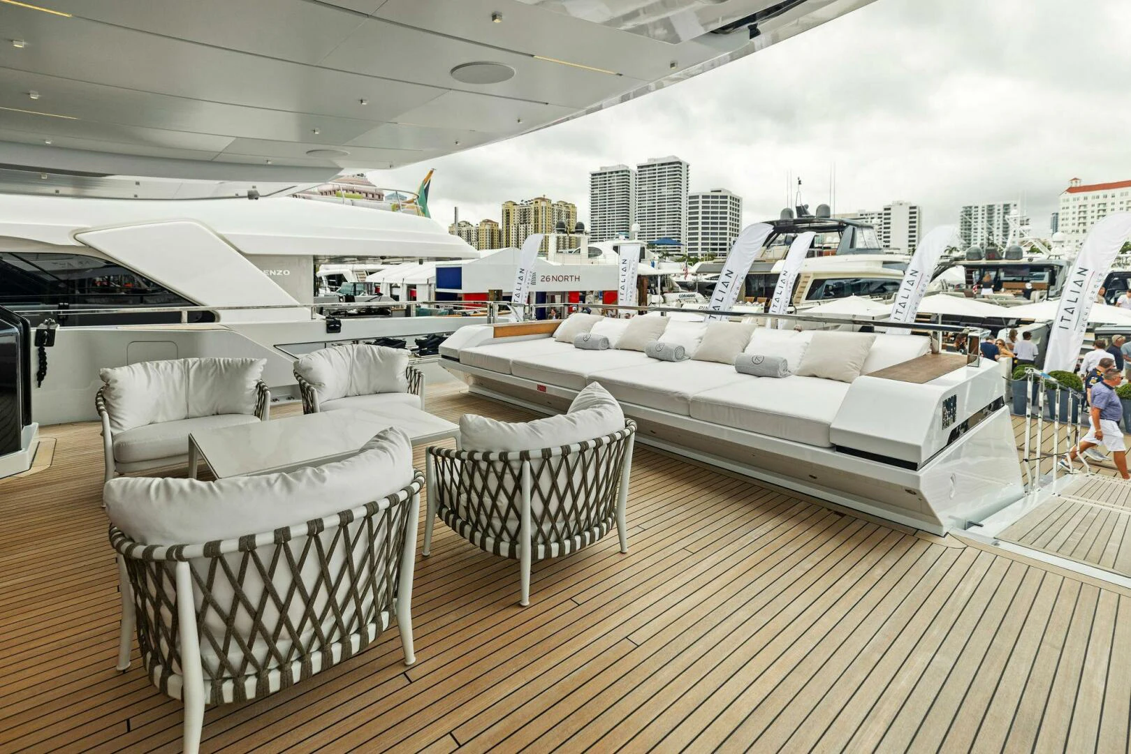 a group of white chairs on a deck next to a large white boat aboard KAMAKASA Yacht for Sale