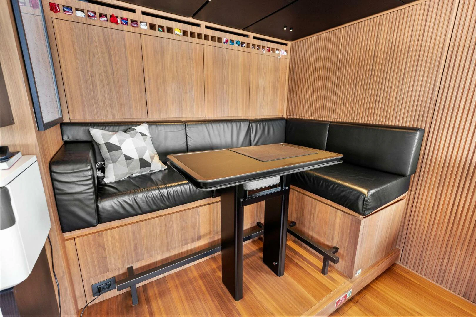 a couch and a table in a room aboard KAMAKASA Yacht for Sale