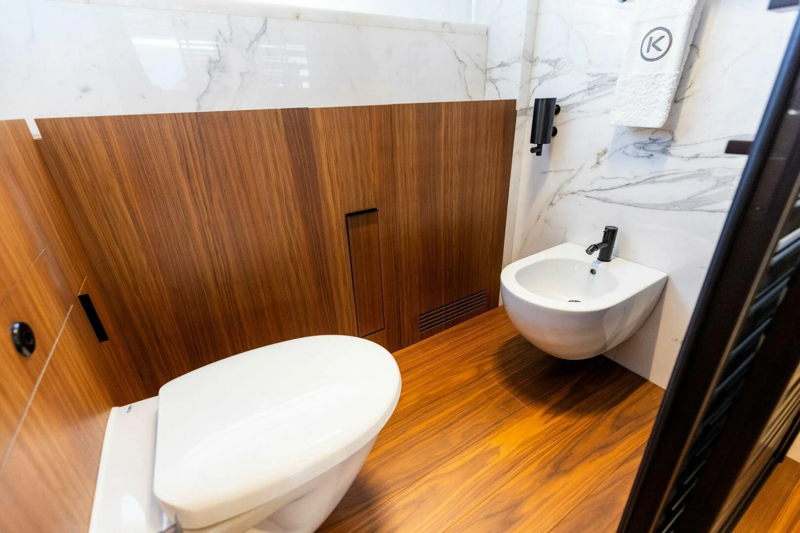 a bathroom with a toilet and sink aboard KAMAKASA Yacht for Sale