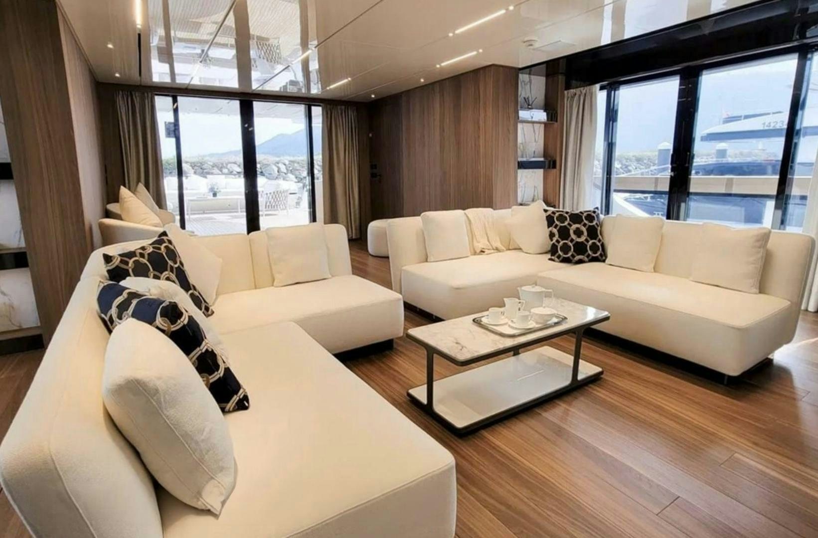 a living room with a couch and a coffee table aboard KAMAKASA Yacht for Sale