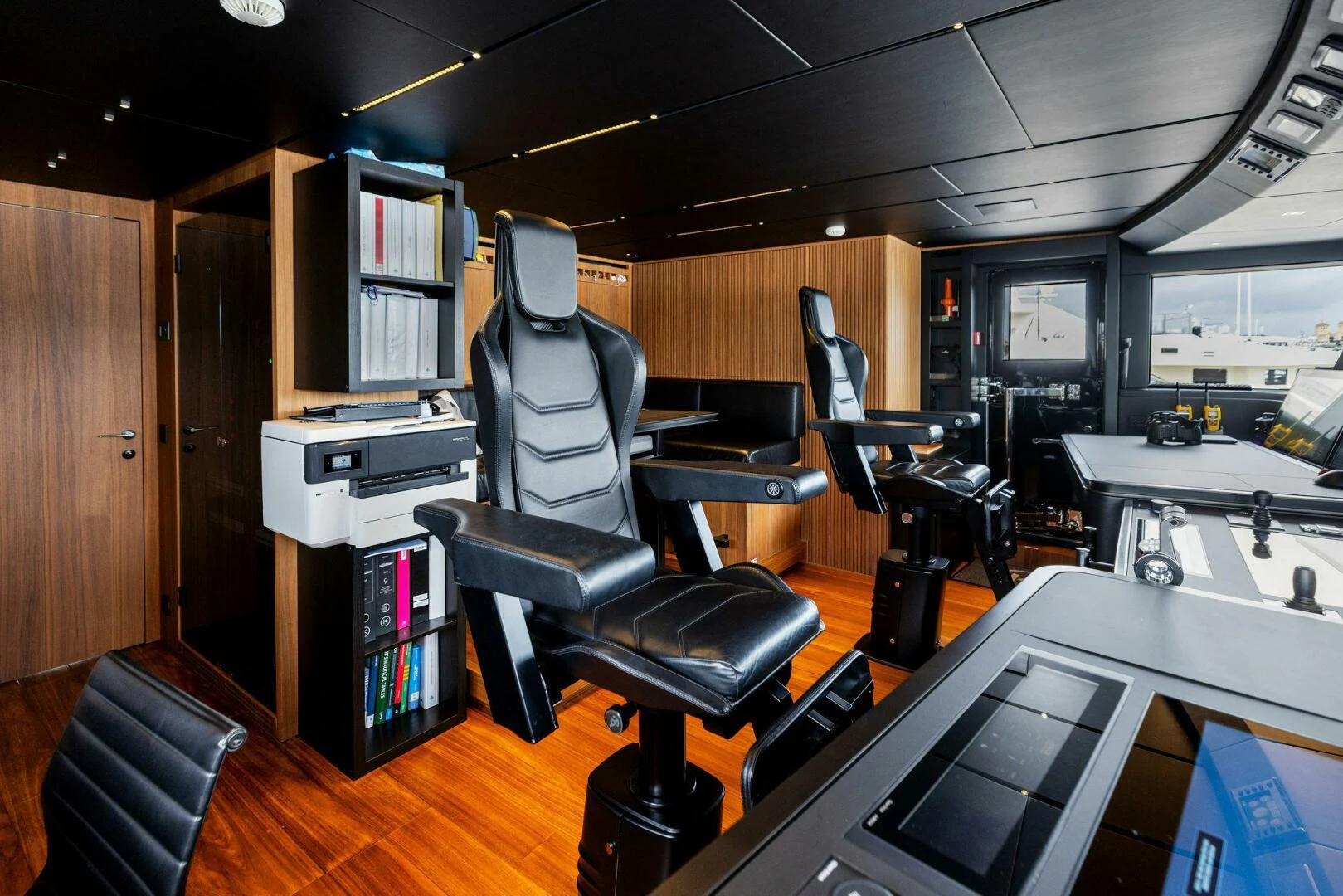 a room with a desk and chairs aboard KAMAKASA Yacht for Sale