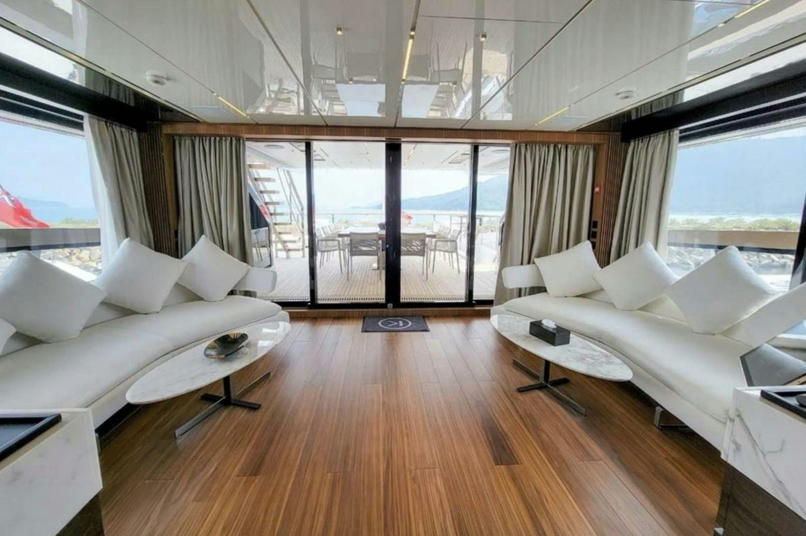 a living room with a large window aboard KAMAKASA Yacht for Sale