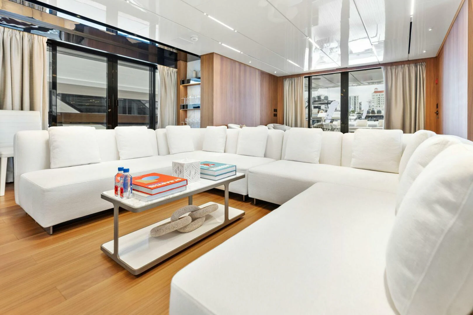 a living room with a white couch and a coffee table aboard KAMAKASA Yacht for Sale