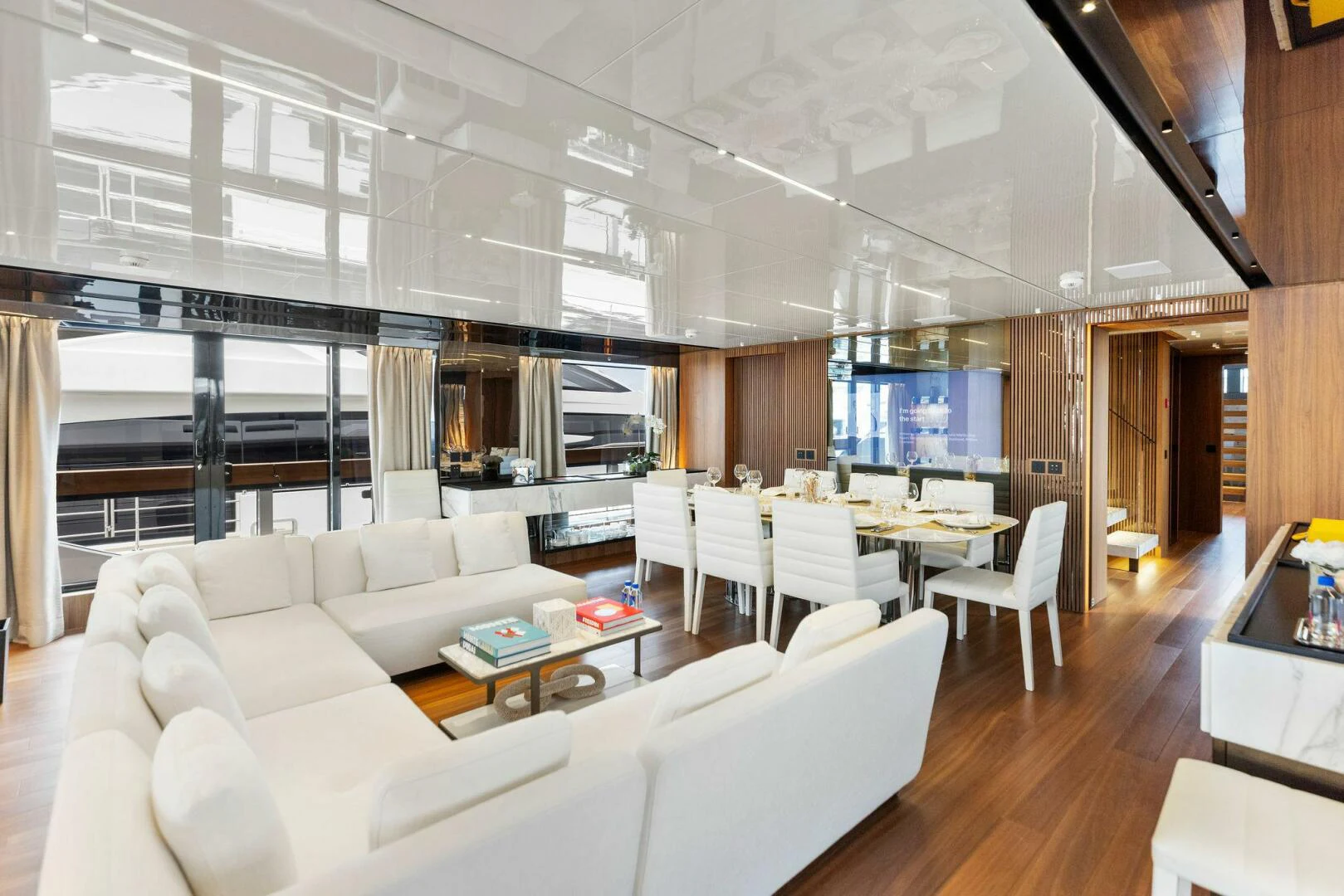 a living room with white furniture aboard KAMAKASA Yacht for Sale