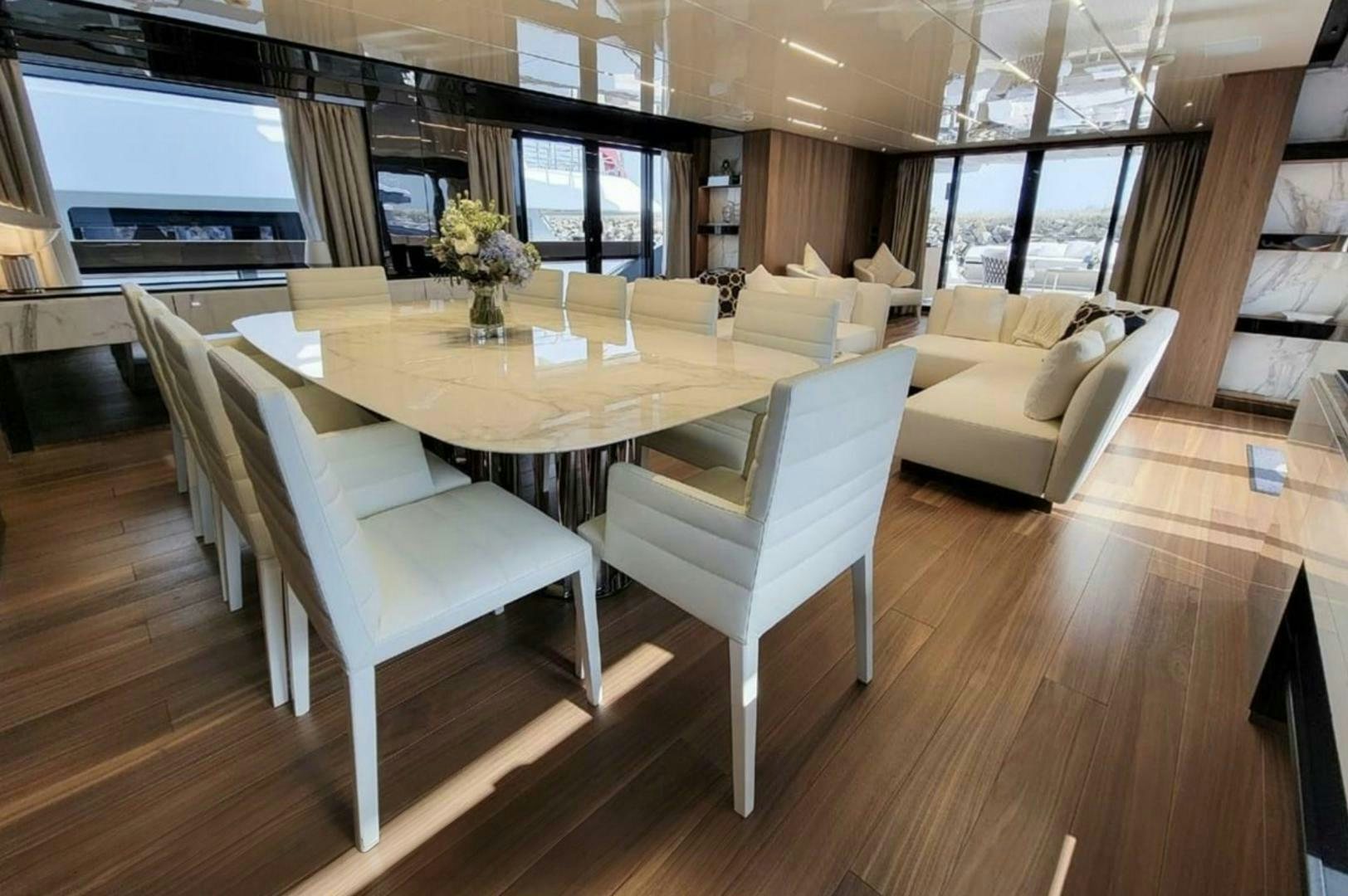 a room with a table chairs and a couch aboard KAMAKASA Yacht for Sale