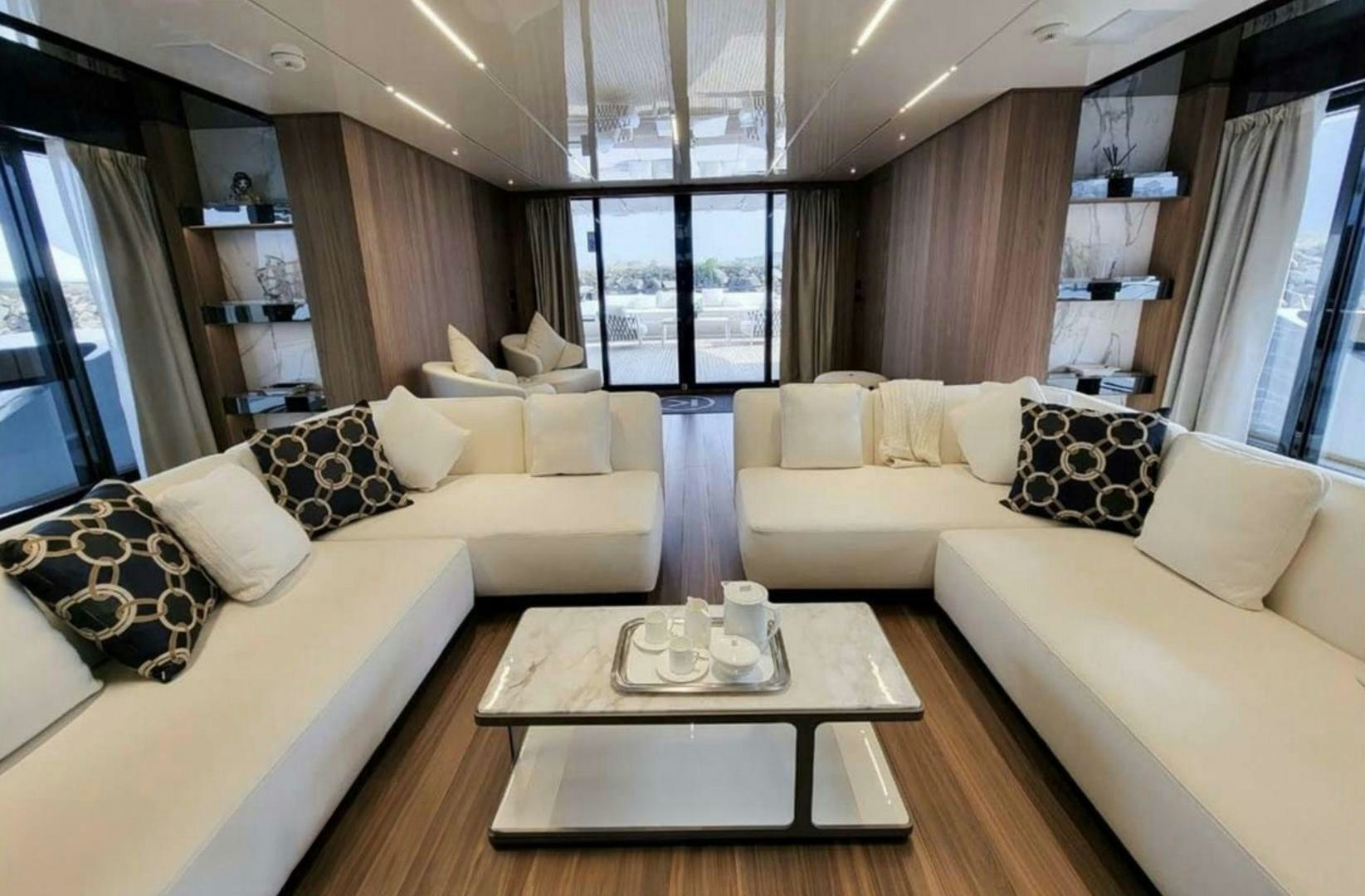 a living room with a couch and a coffee table aboard KAMAKASA Yacht for Sale