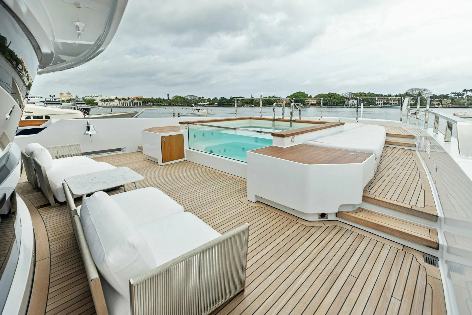 a room with a pool and a deck with a view of the water aboard KAMAKASA Yacht for Sale