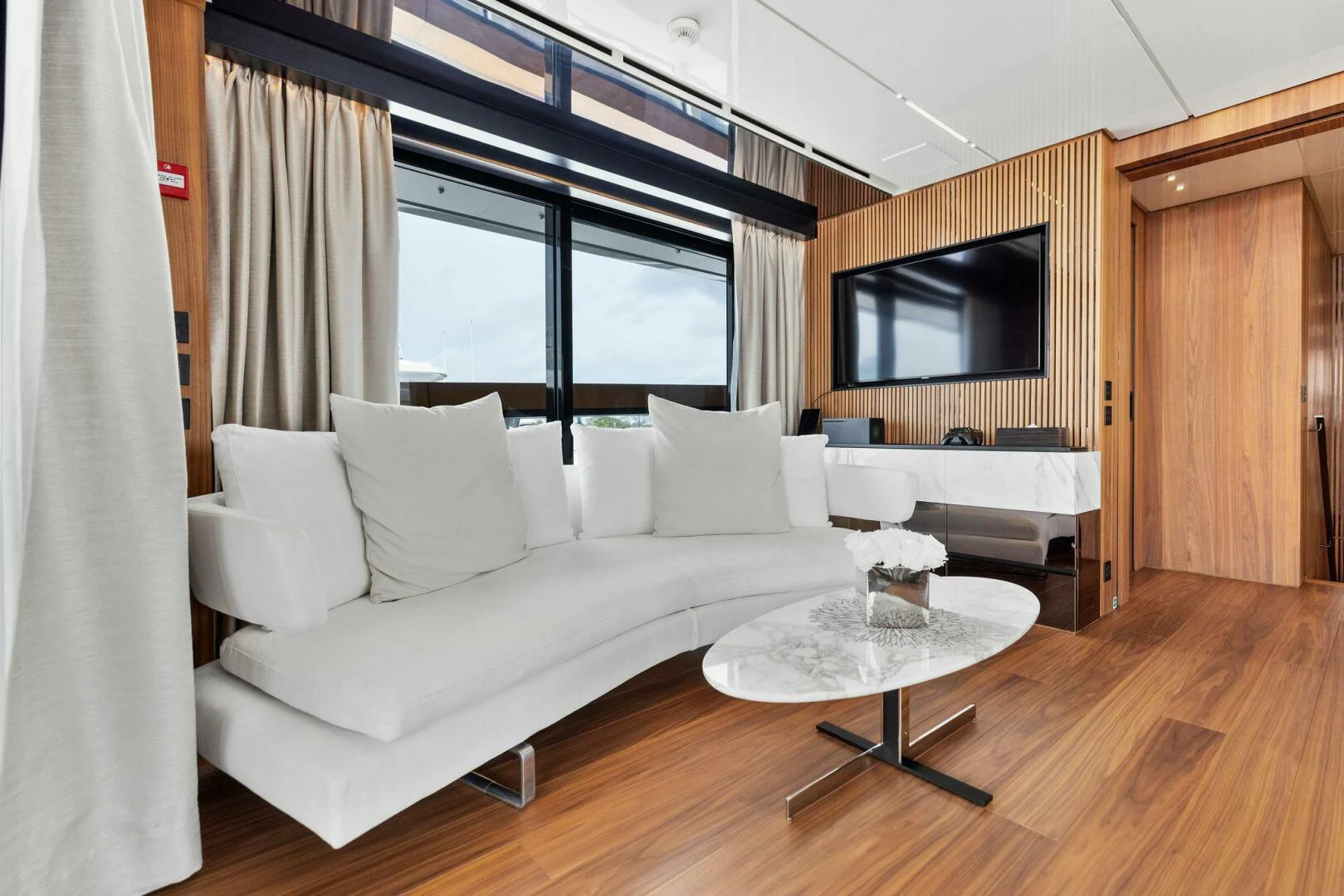 a living room with a white couch aboard KAMAKASA Yacht for Sale
