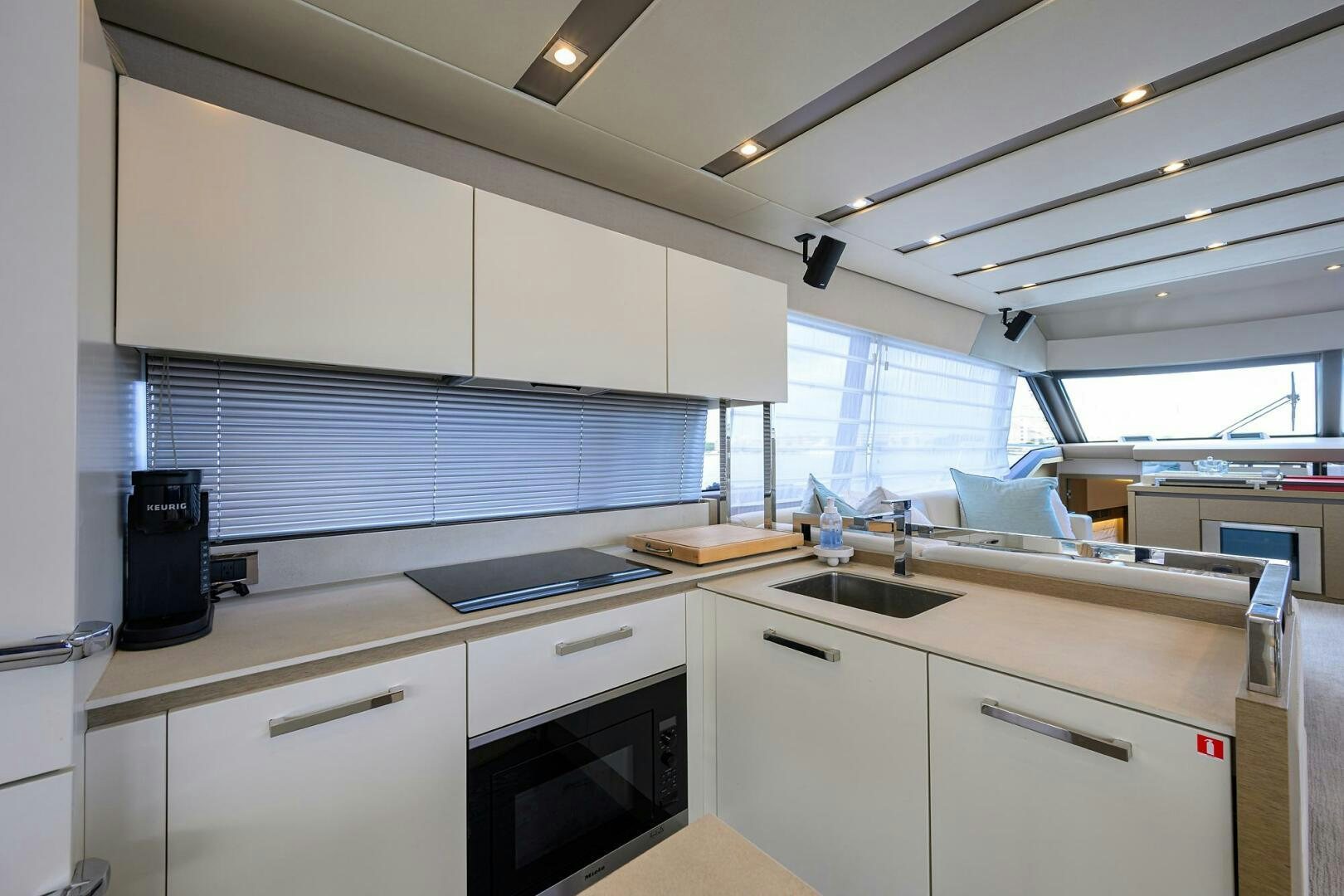 a kitchen with white cabinets aboard 2016 68 PRESTIGE Yacht for Sale