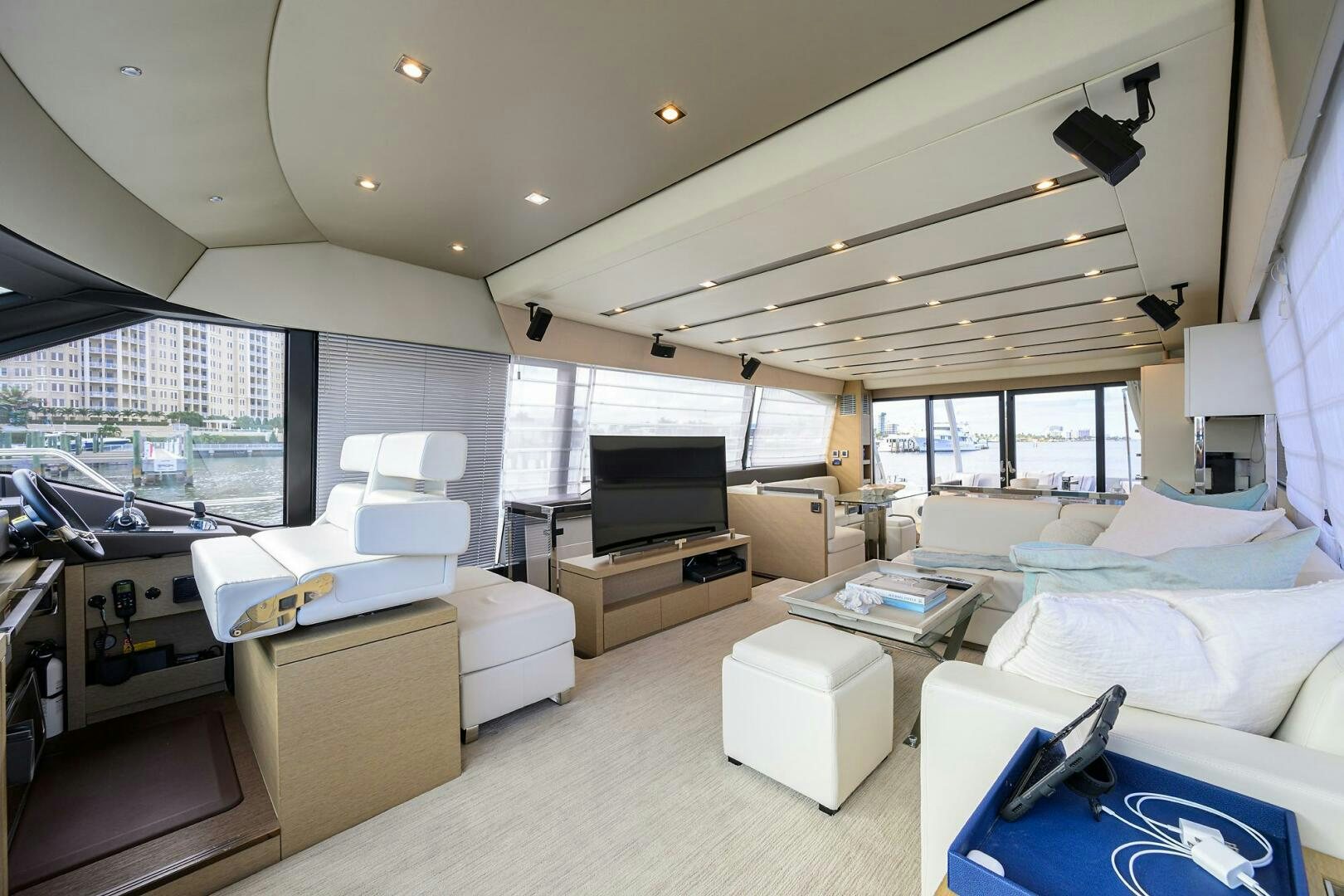 a room with a large window and a large bed aboard 2016 68 PRESTIGE Yacht for Sale