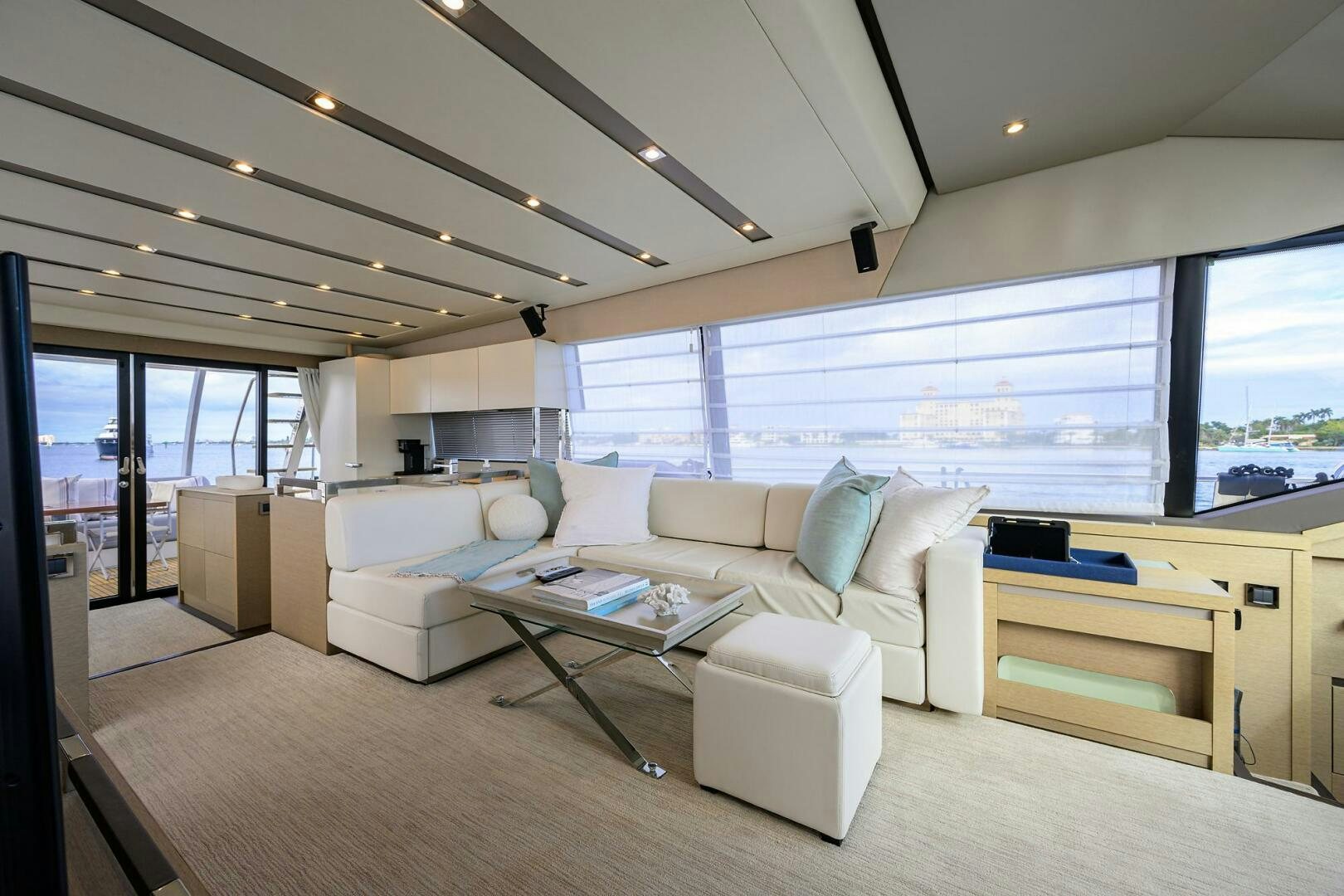 a living room with a large window aboard 2016 68 PRESTIGE Yacht for Sale
