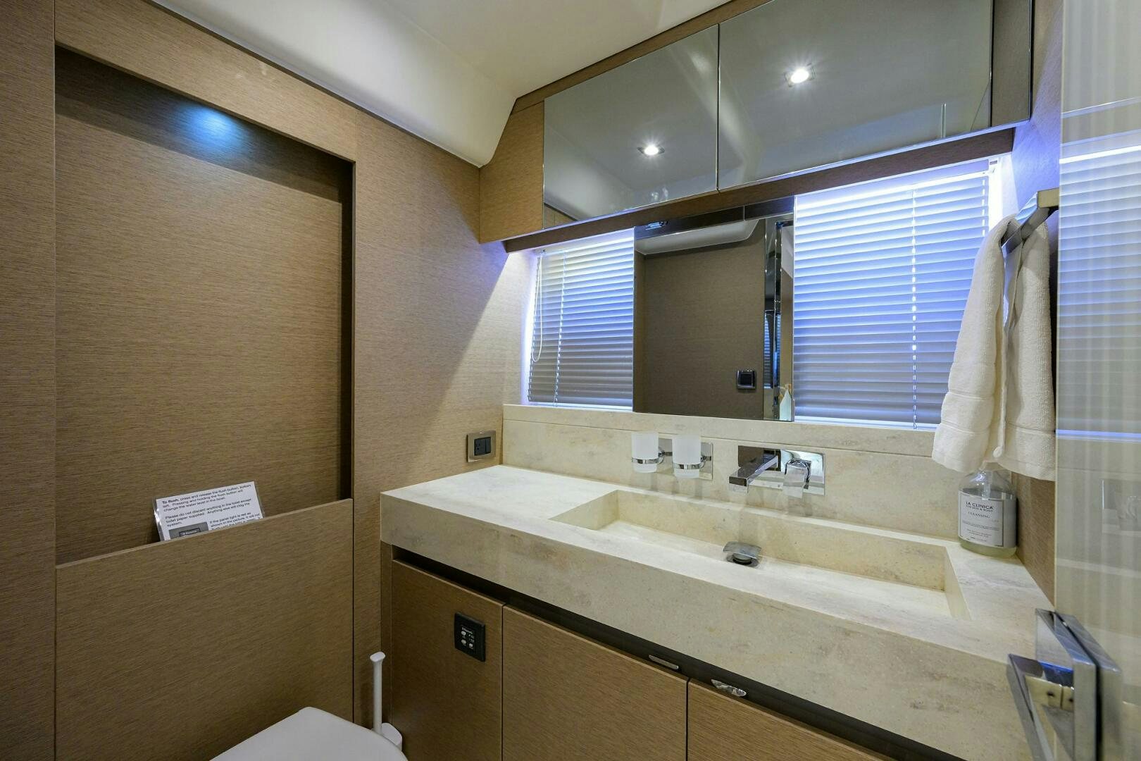 a bathroom with a large mirror aboard 2016 68 PRESTIGE Yacht for Sale