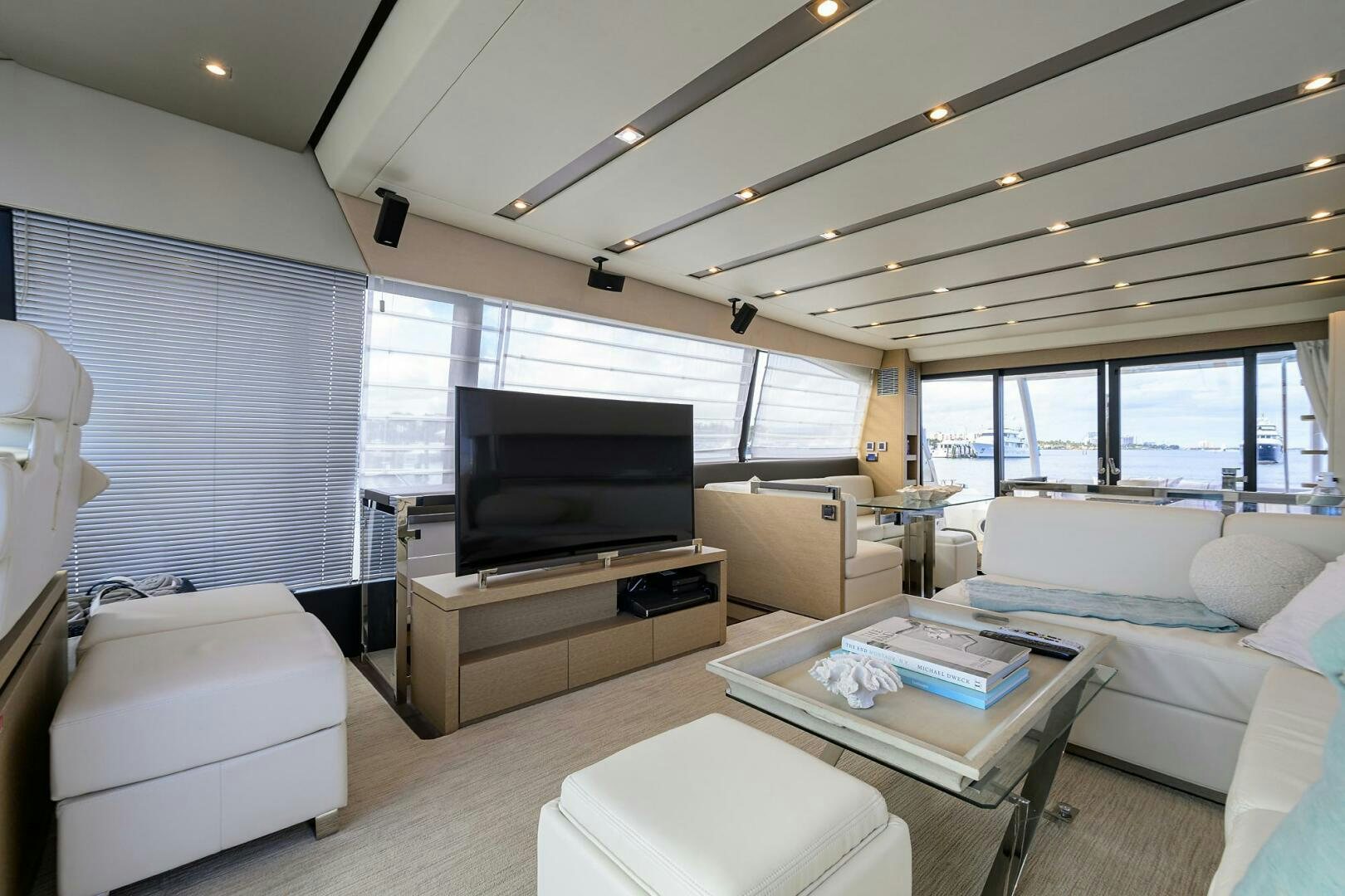a living room with a large screen aboard 2016 68 PRESTIGE Yacht for Sale
