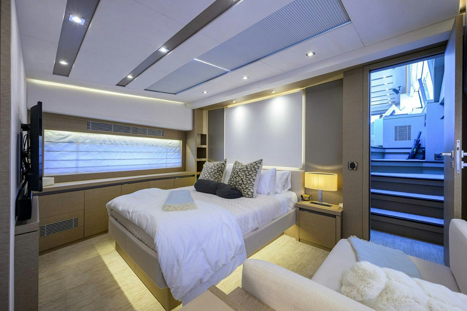 a room with a bed and a tv aboard 2016 68 PRESTIGE Yacht for Sale