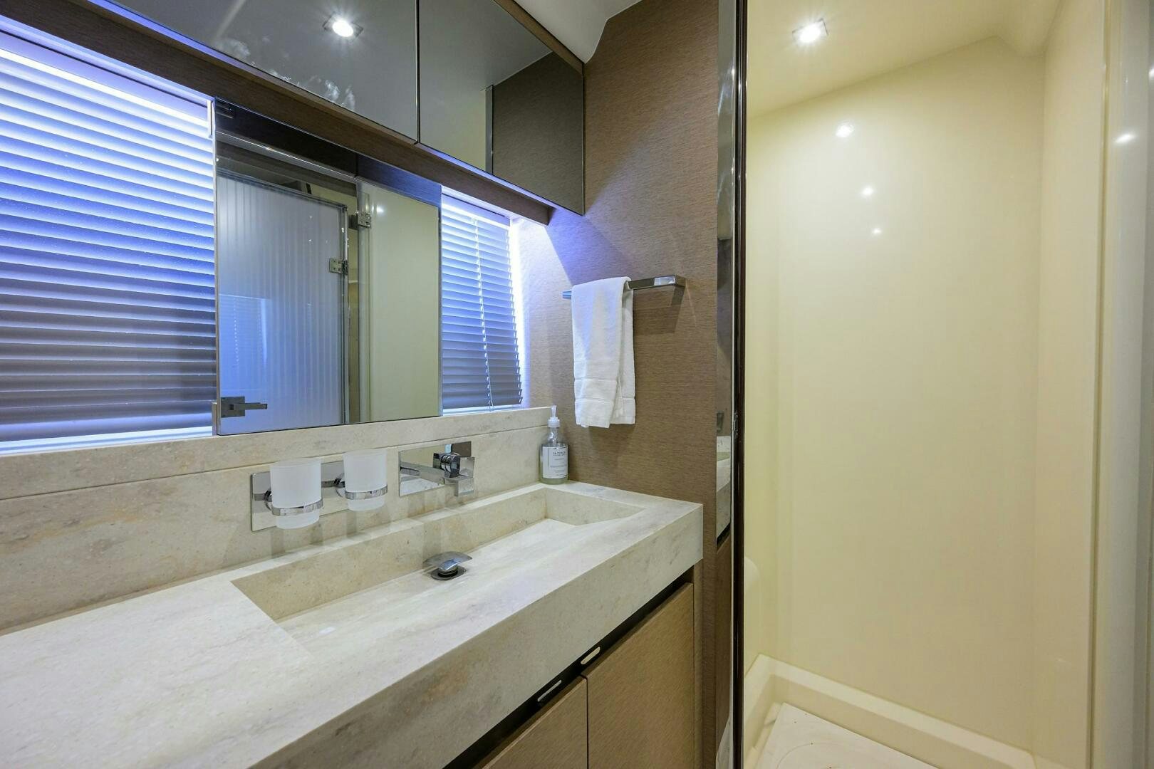 a bathroom with a large mirror aboard 2016 68 PRESTIGE Yacht for Sale