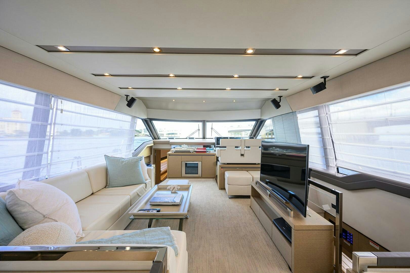 a living room with a large window aboard 2016 68 PRESTIGE Yacht for Sale