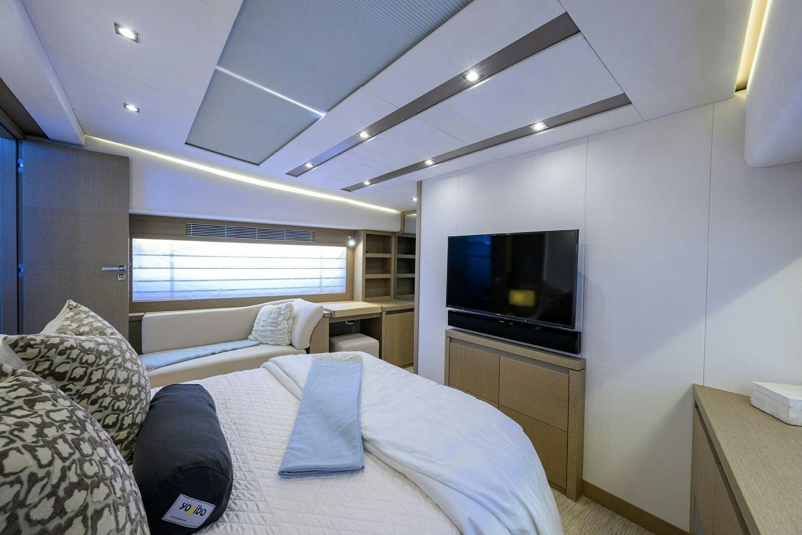 a bedroom with a bed and a tv aboard 2016 68 PRESTIGE Yacht for Sale