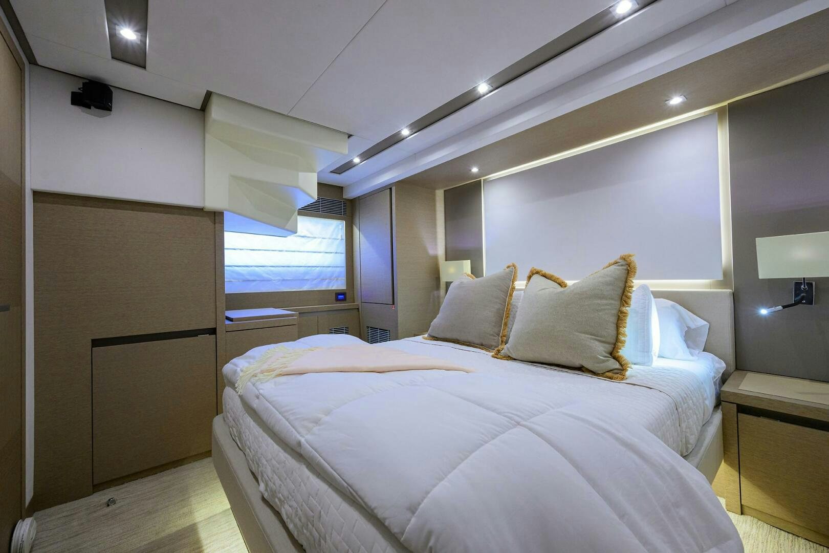 a room with a bed and a window aboard 2016 68 PRESTIGE Yacht for Sale