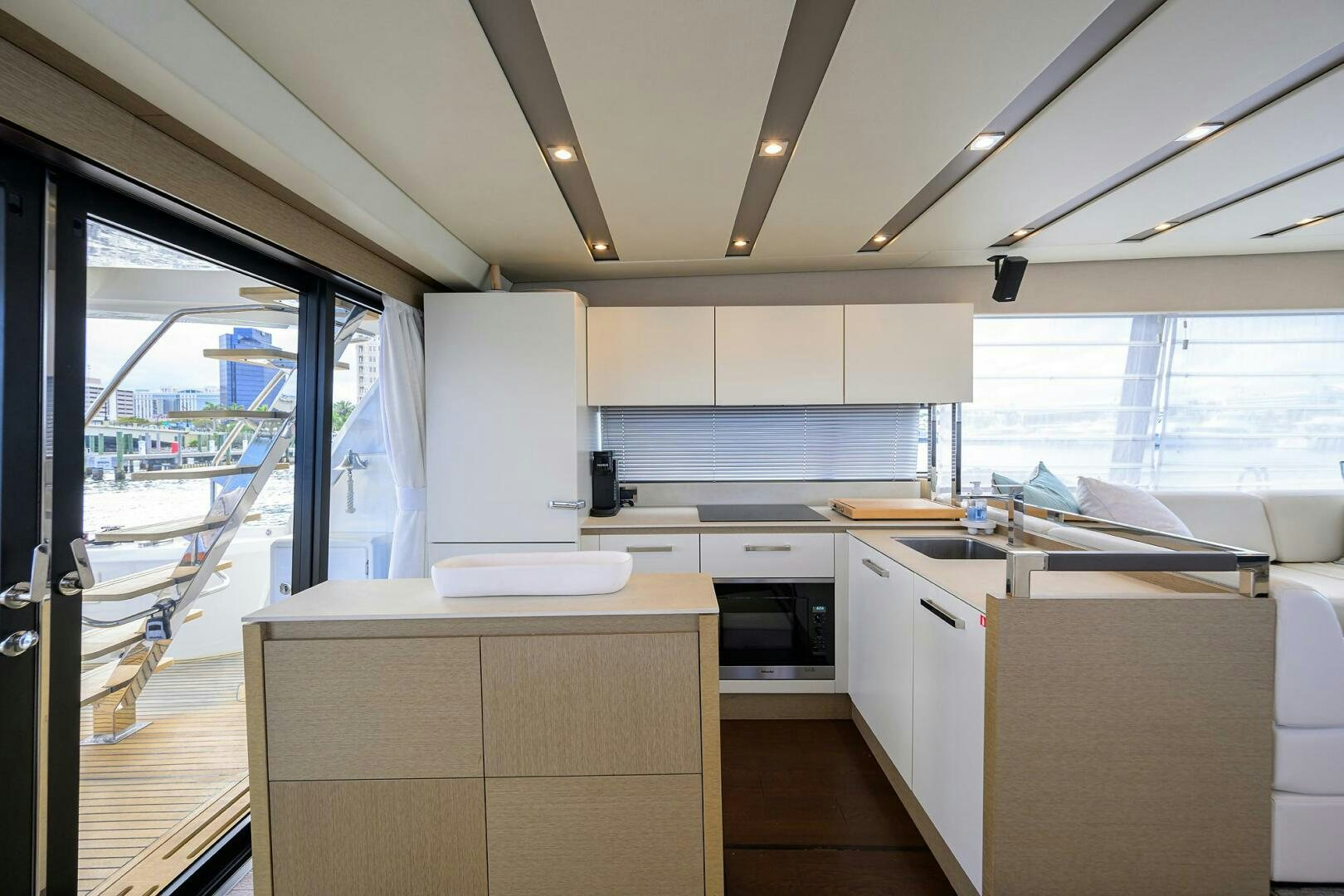 a kitchen with white cabinets aboard 2016 68 PRESTIGE Yacht for Sale