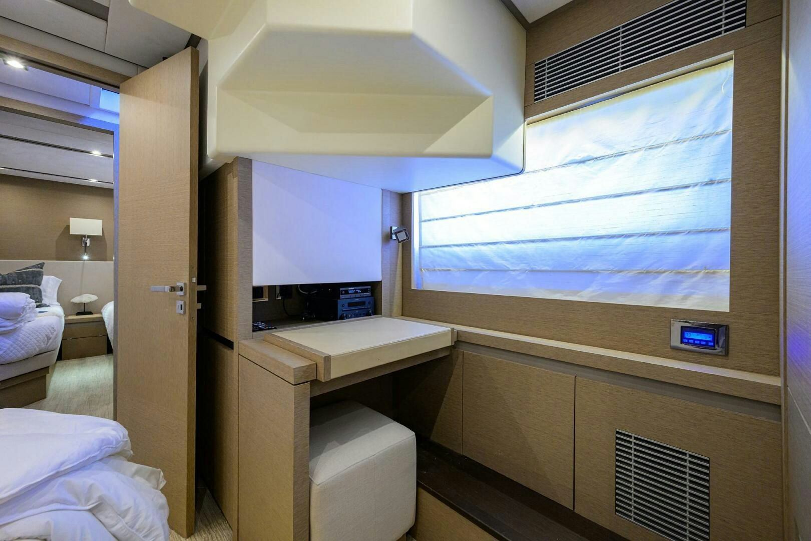 a room with a bed and a desk aboard 2016 68 PRESTIGE Yacht for Sale